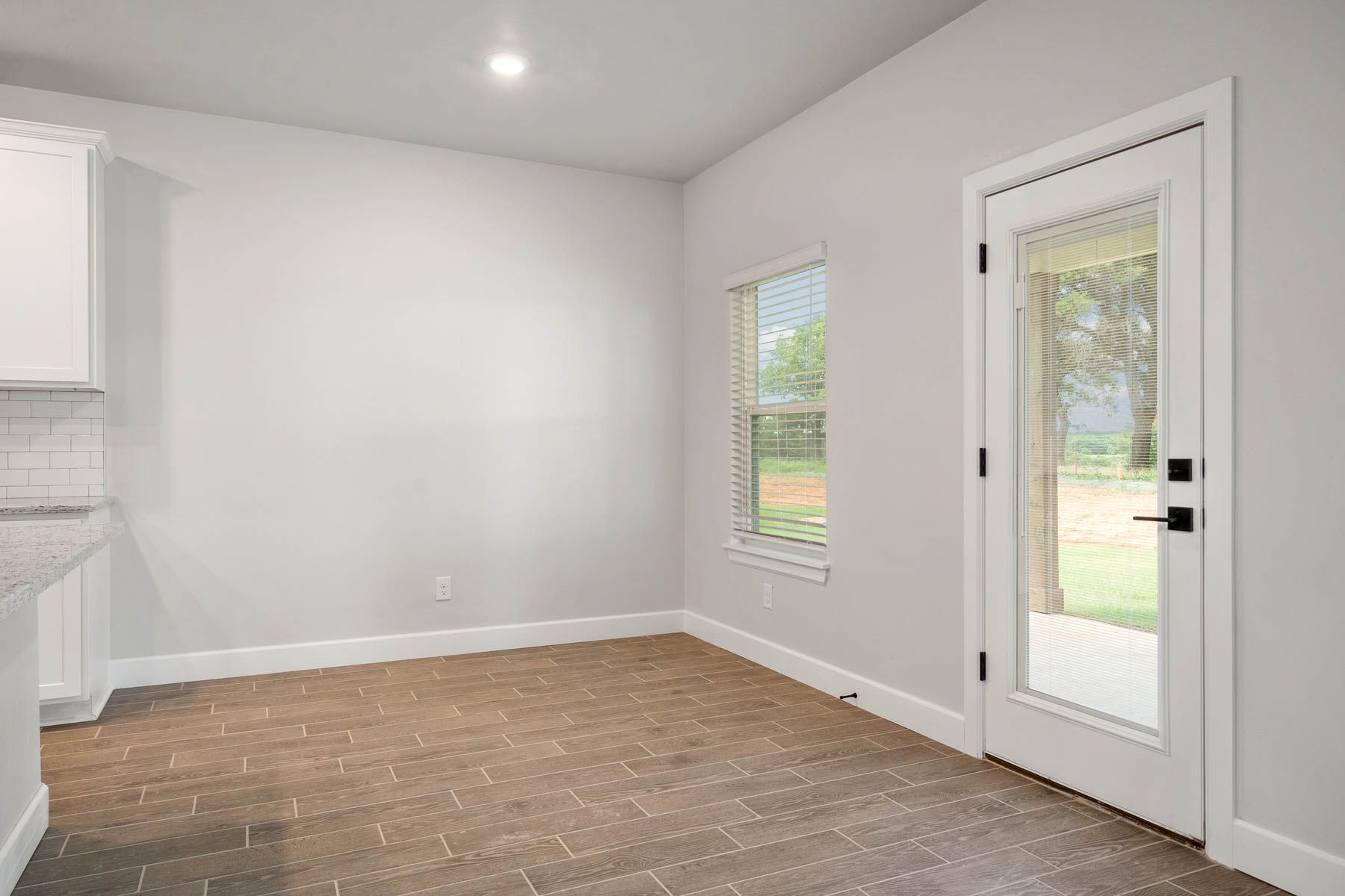 The dining area has a large window that lets in great, natural light.