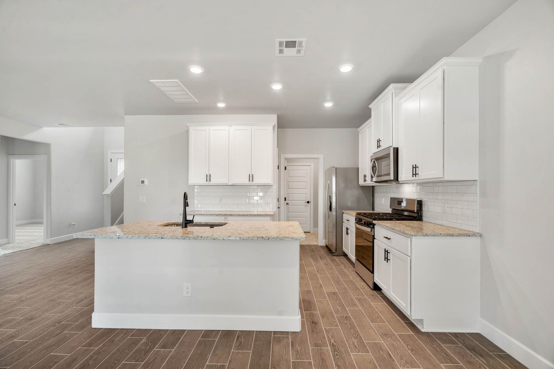 The upgraded kitchen has a gorgeous white cabinetry and matte black finishes.