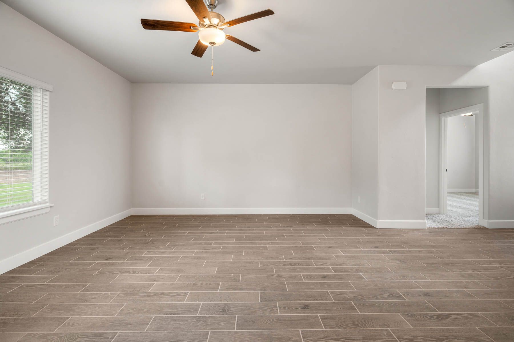 The family room is spacious and has large windows.