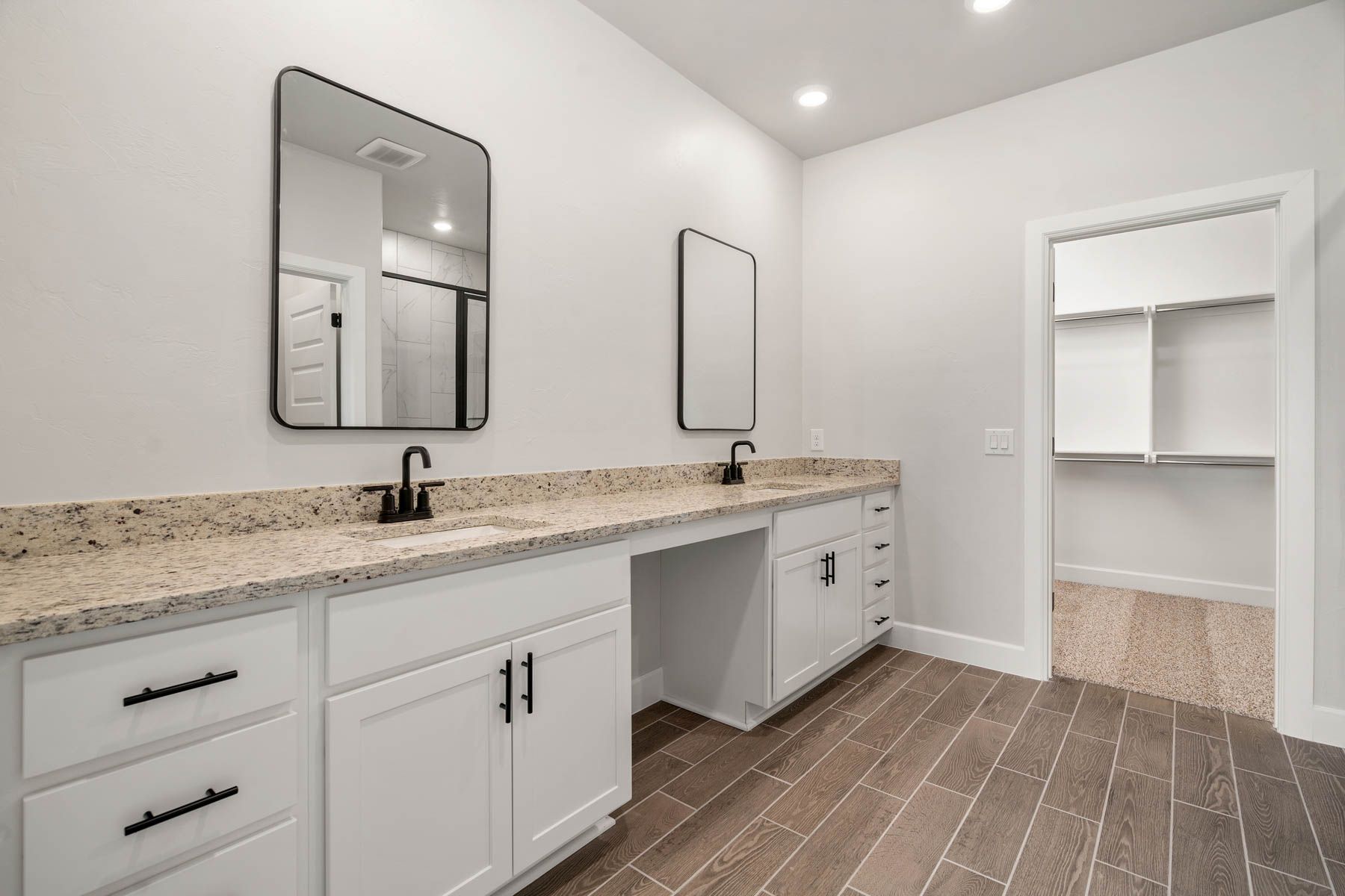 The master bathroom has a large, dual-sink vanity.