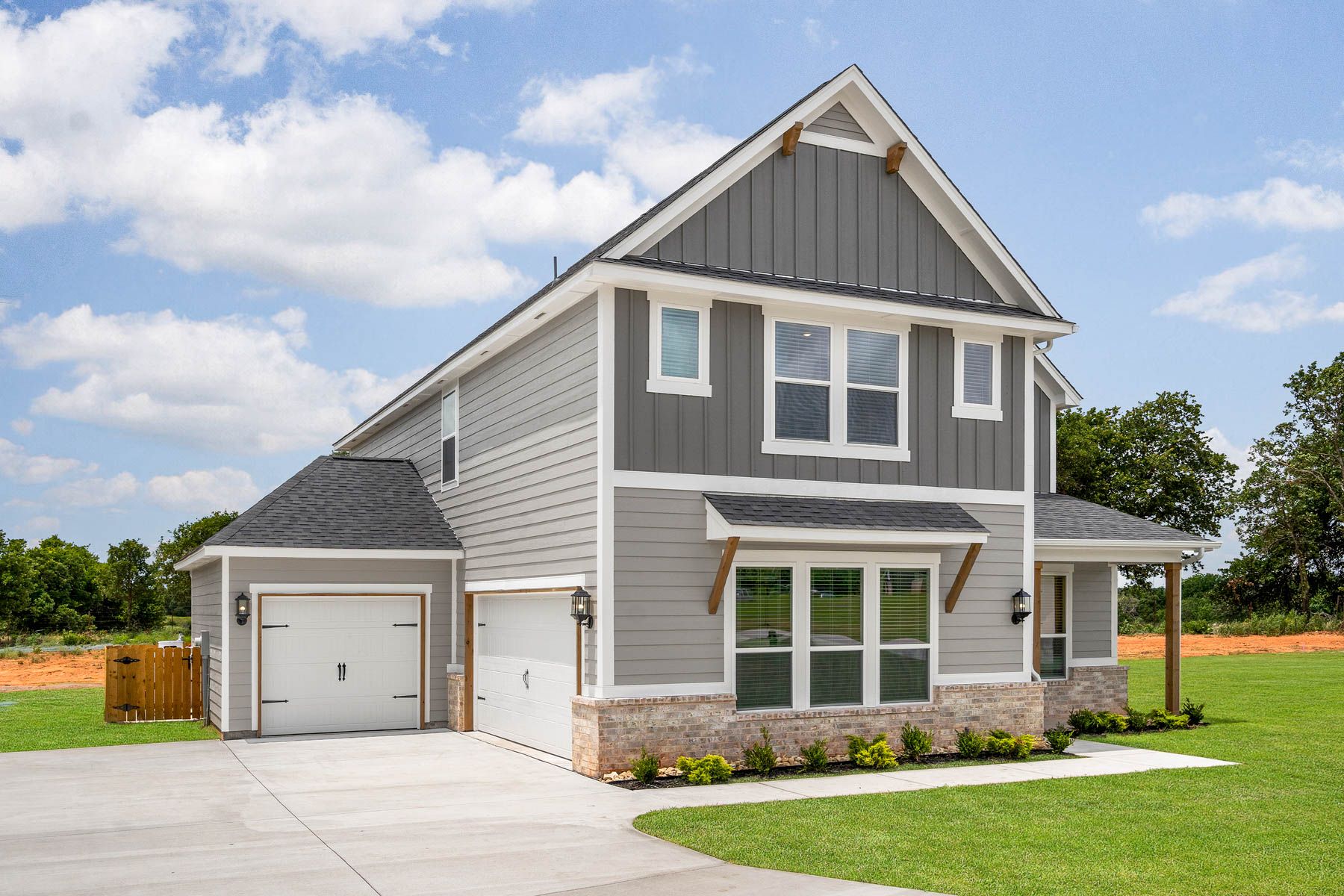 The Woods is a beautiful two-story siding home with brick detailing.