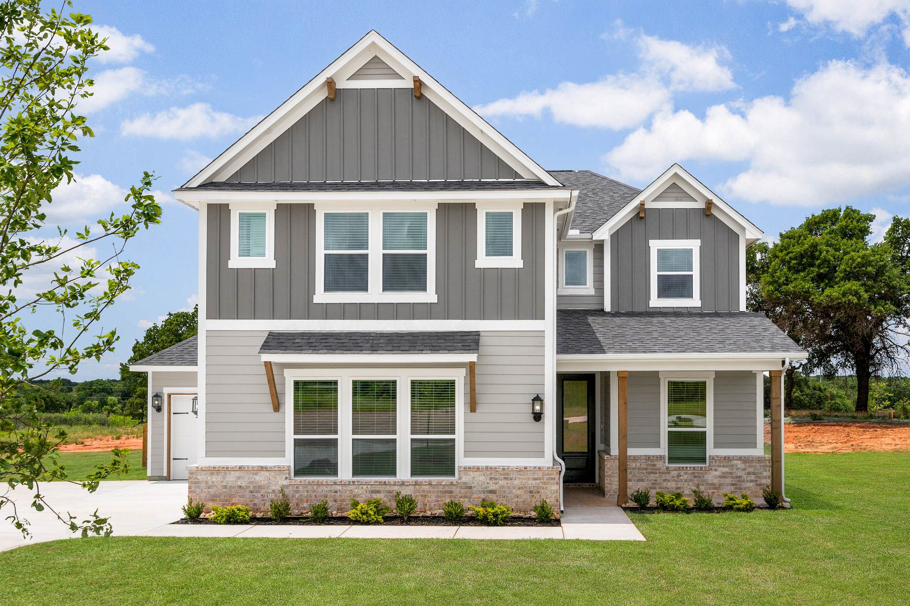 The Woods is a beautiful two-story siding home with brick detailing.