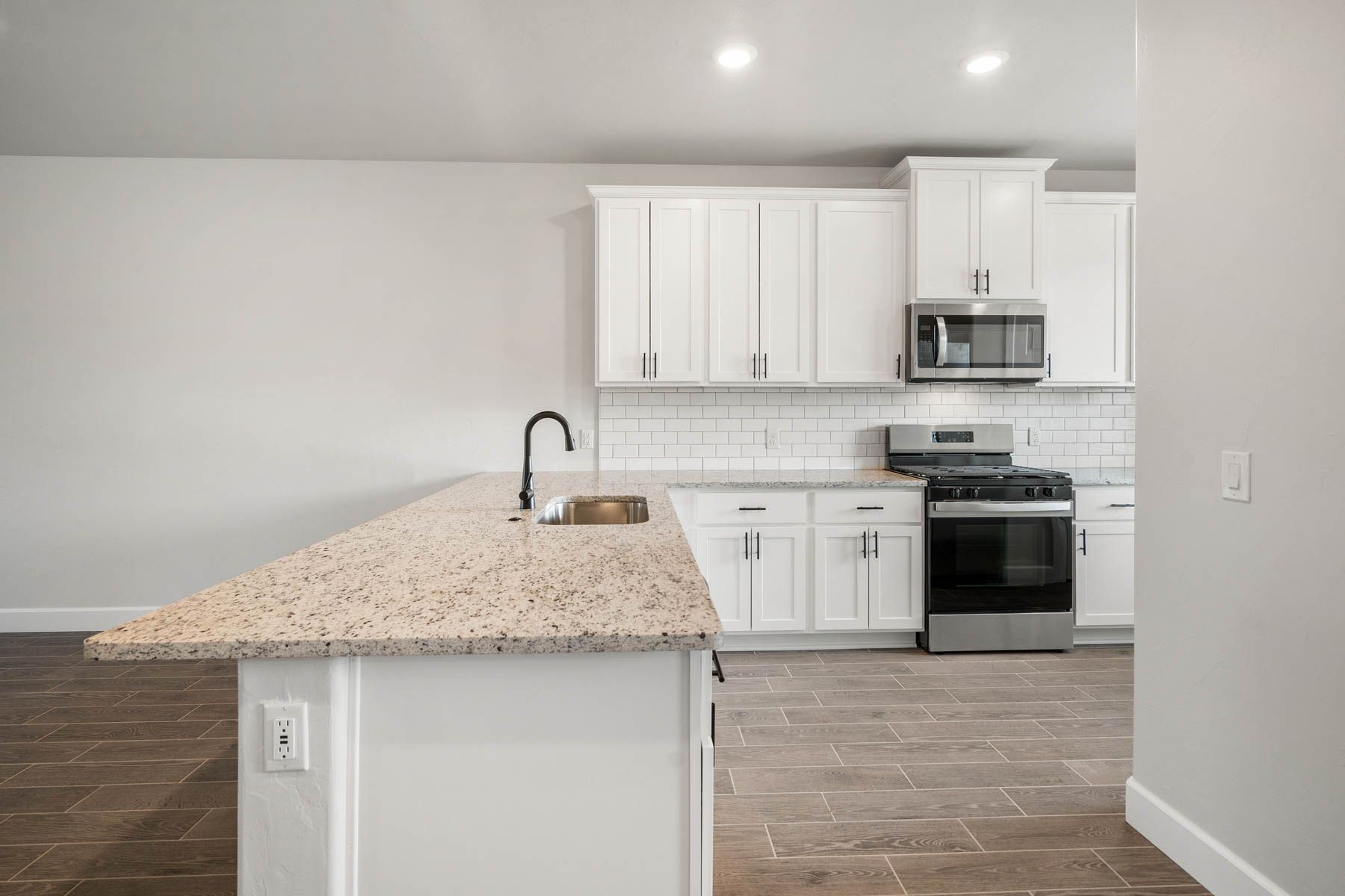 The kitchen has sprawling granite countertops.