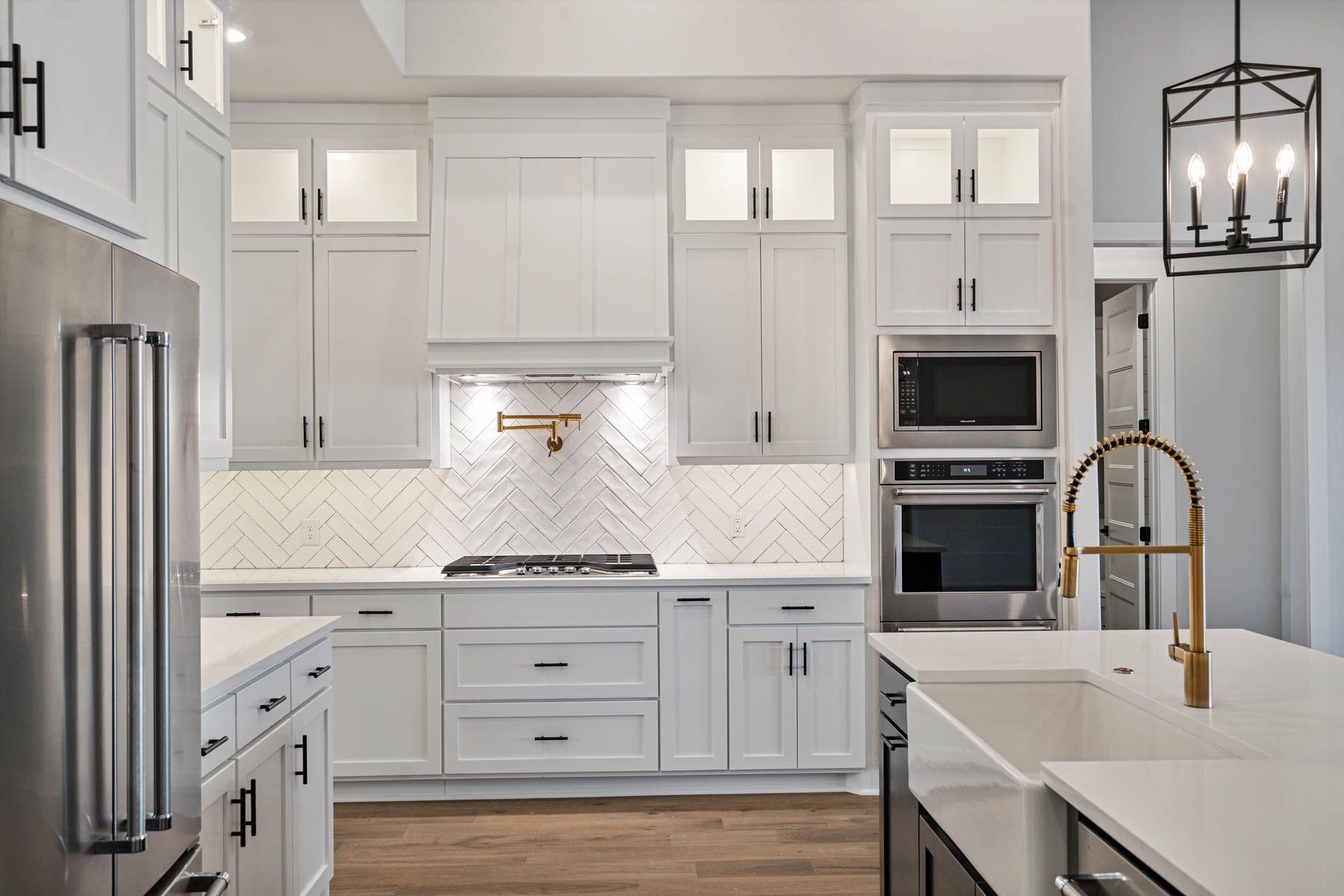 The kitchen of the Hefner has a stacked ovens and a gas range.