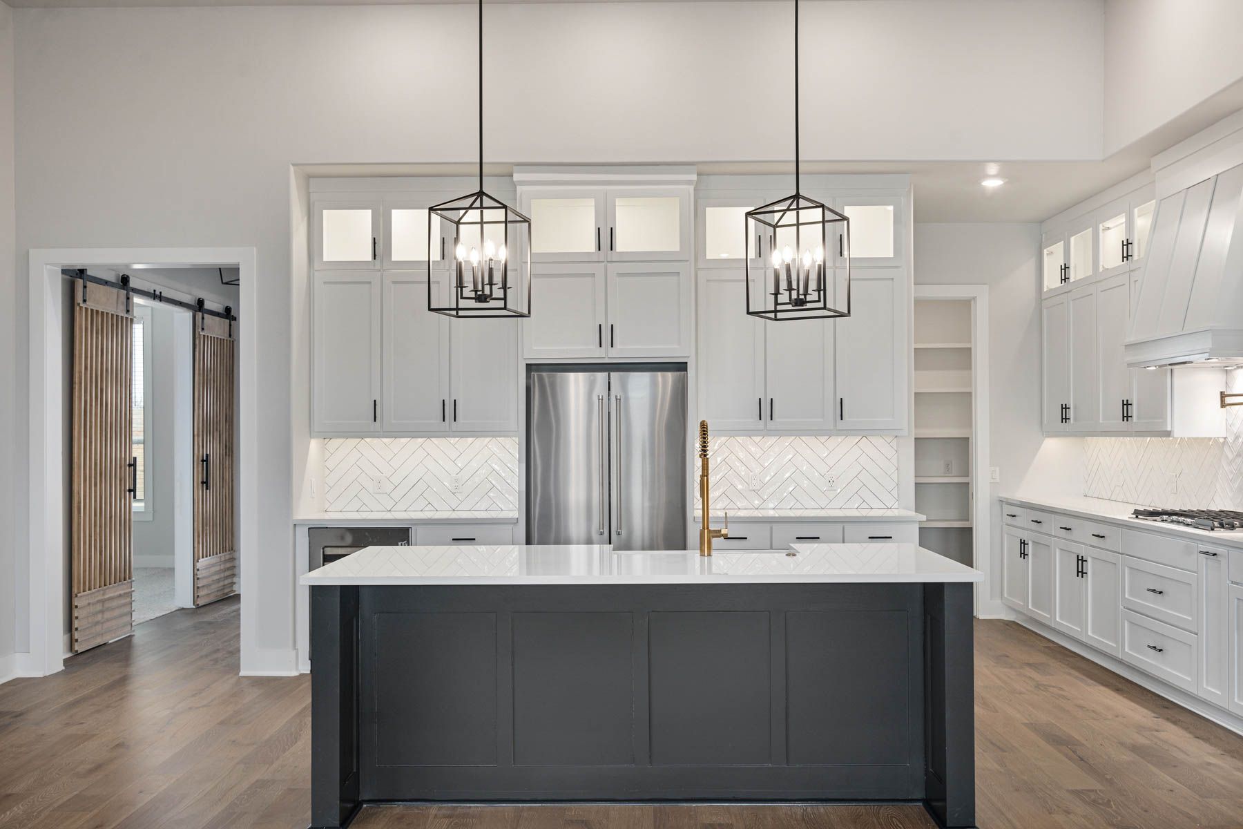 The kitchen of the Hefner has a large islands with quartz countertops.