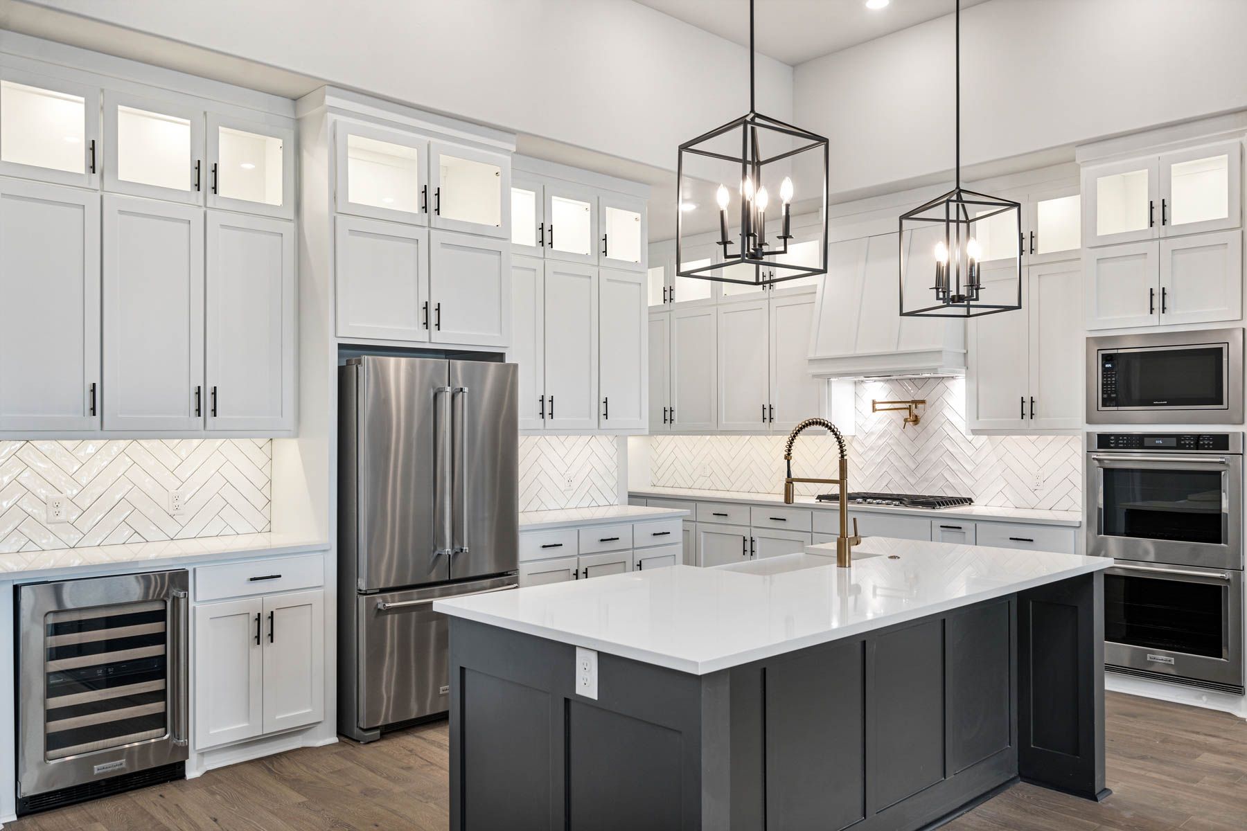 The kitchen of the Hefner has a gorgeous wood cabinetry and tile backsplash.