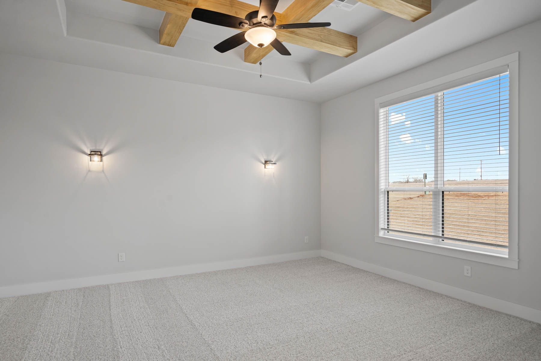 The spacious media room has a large window and is a versatile space.