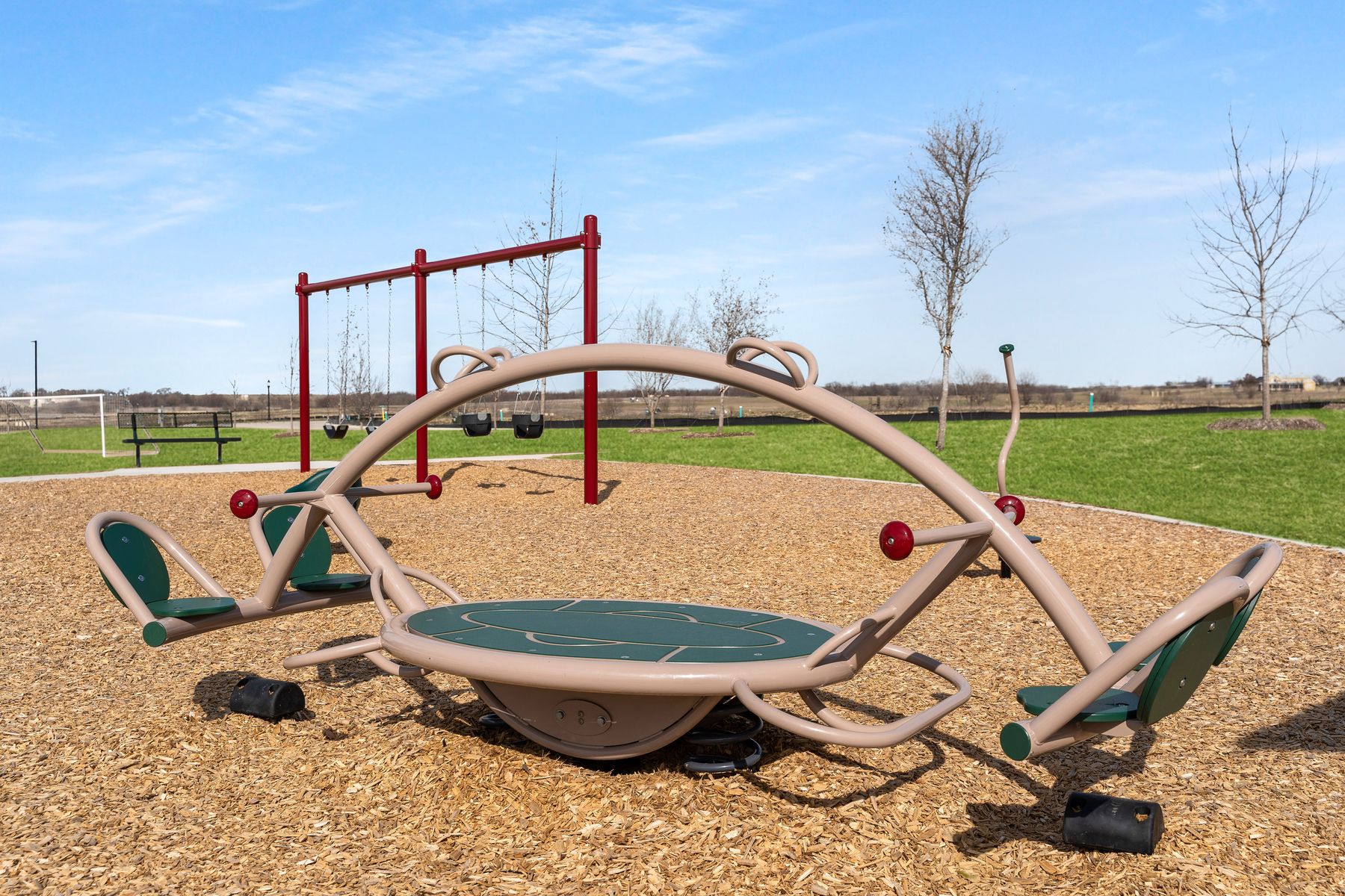The community park includes a seesaw.