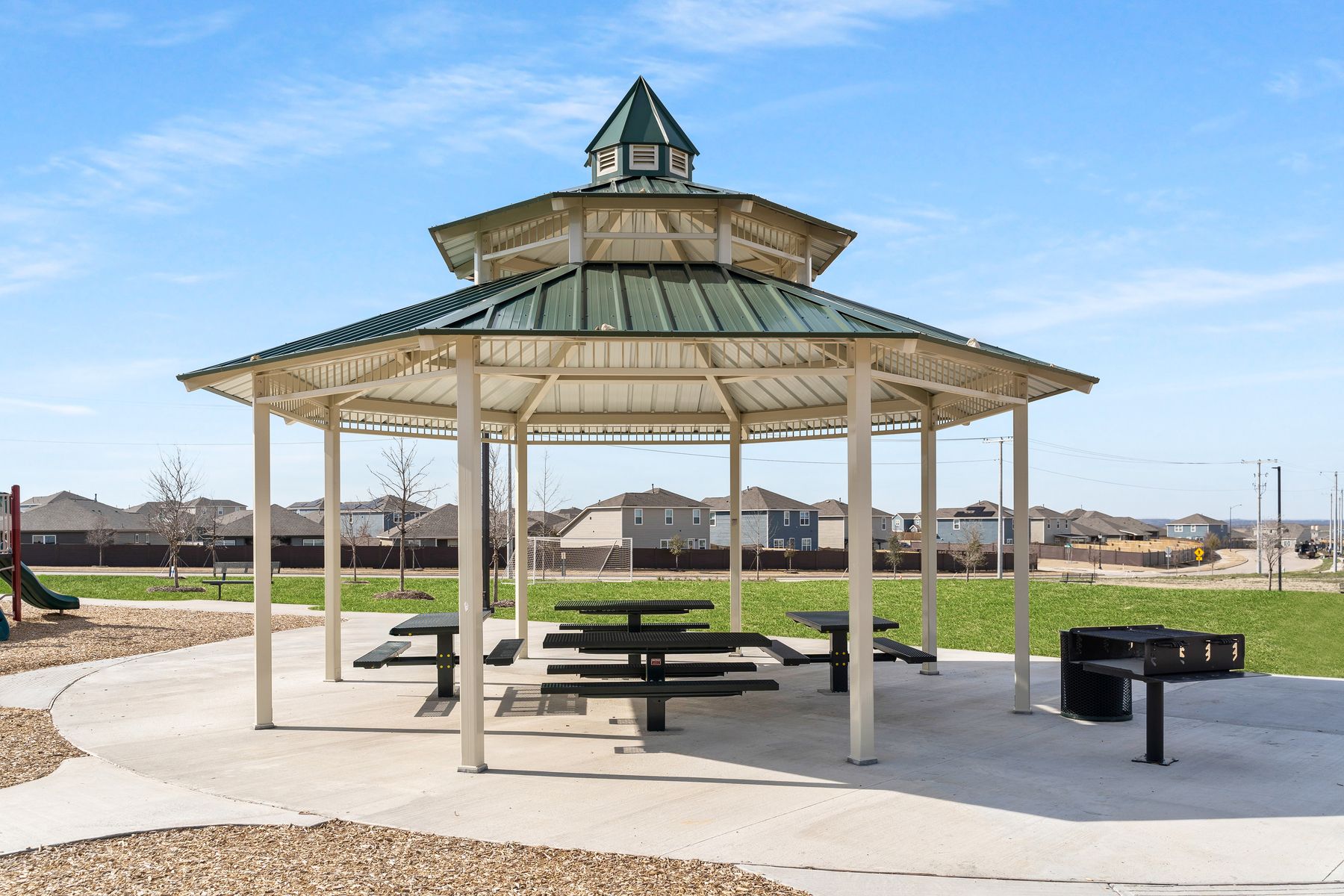 The community park includes a gazebo with picnic tables and grills.