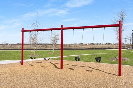 The community park includes a swing set.