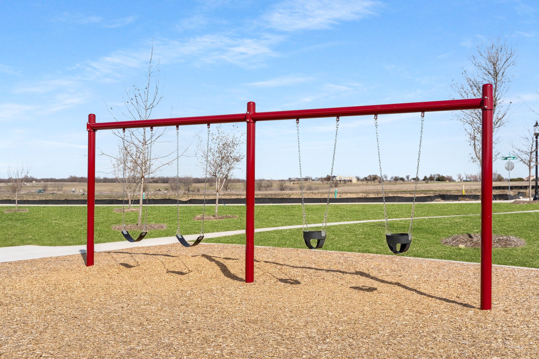 The community park includes a swing set.