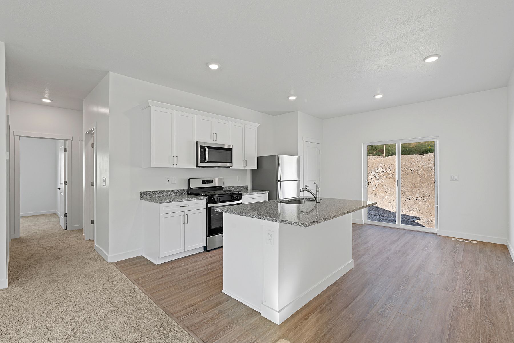 The kitchen has beautiful white wood cabinetry.