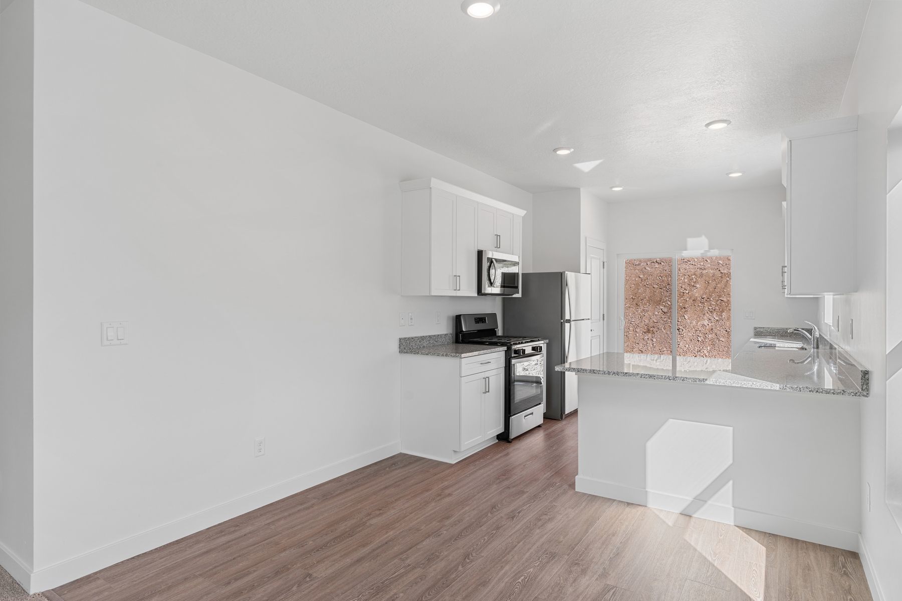 The open living spaces connect the family room with the dining room and kitchen.