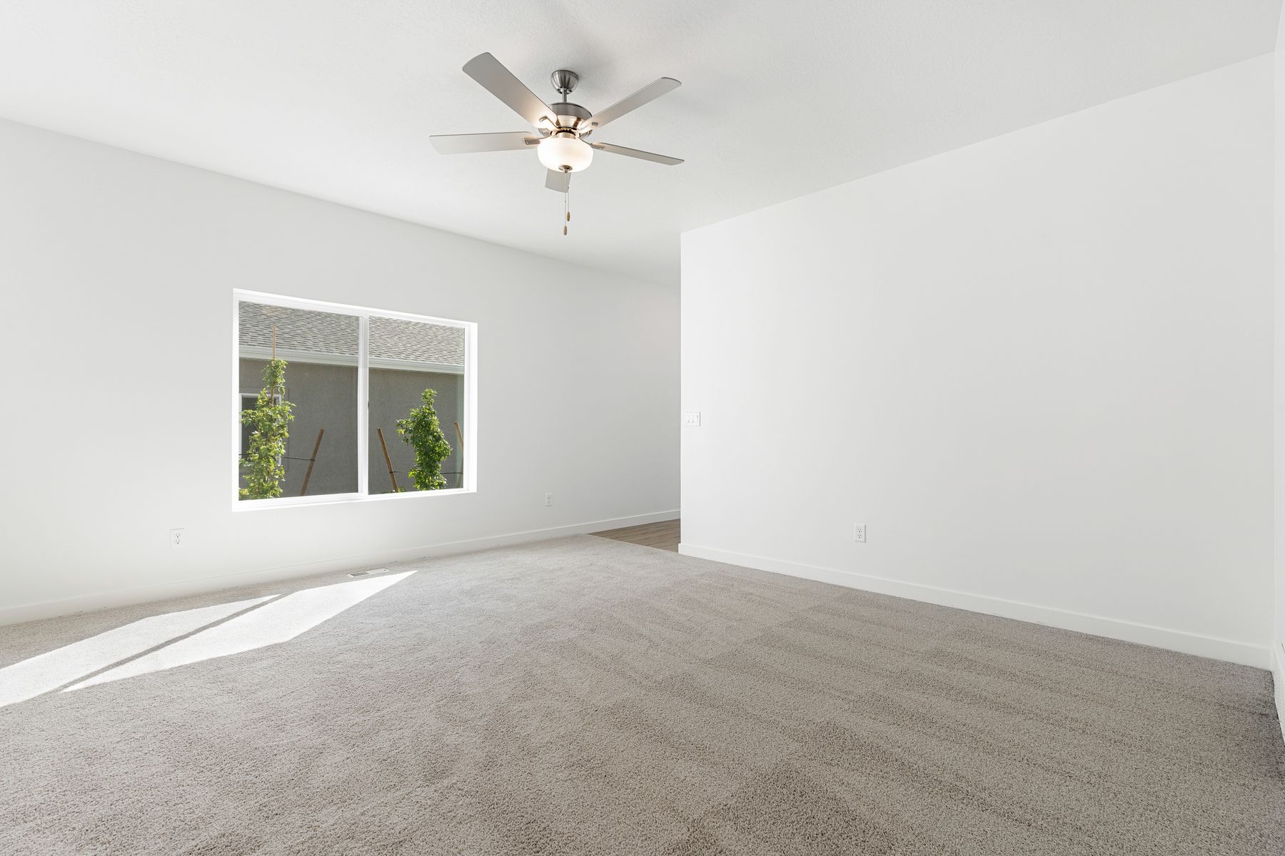 The family room has a large window that lets in great, natural light.