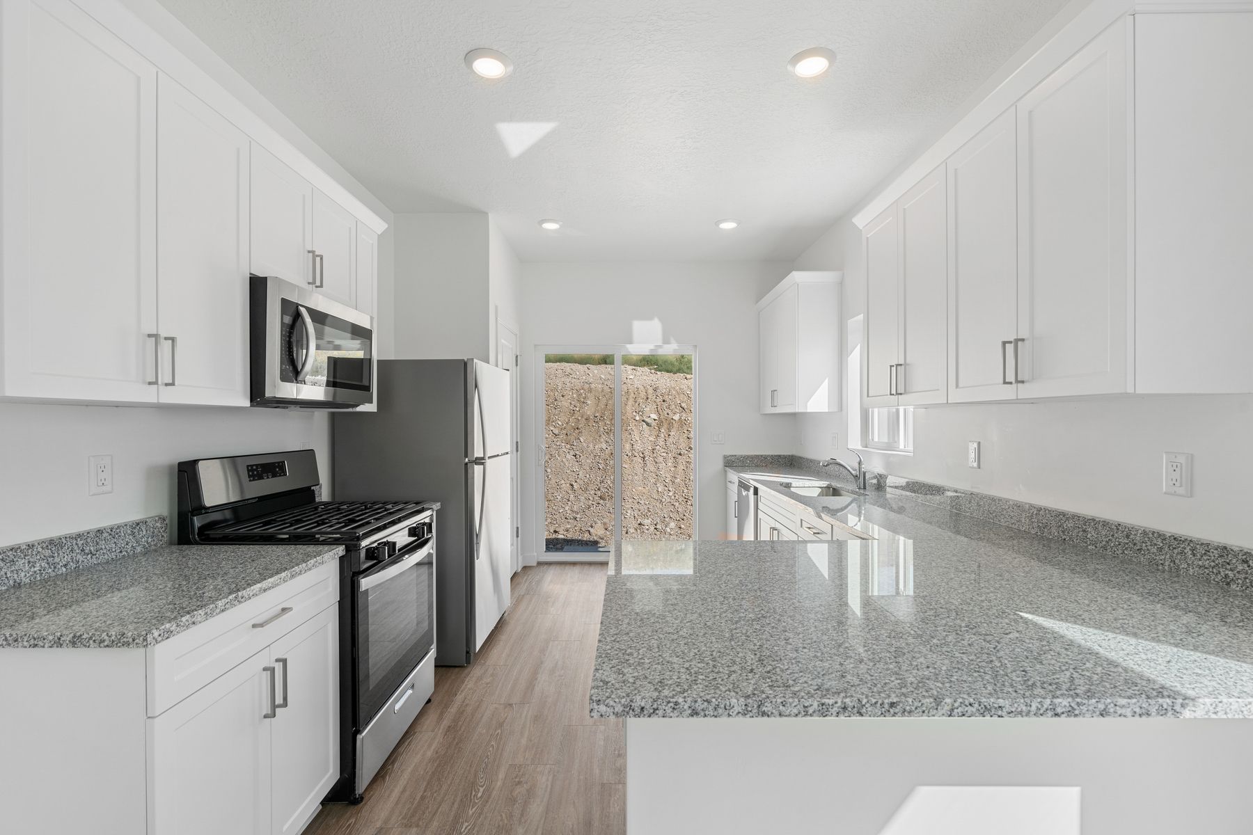 The kitchen has sprawling granite countertops.