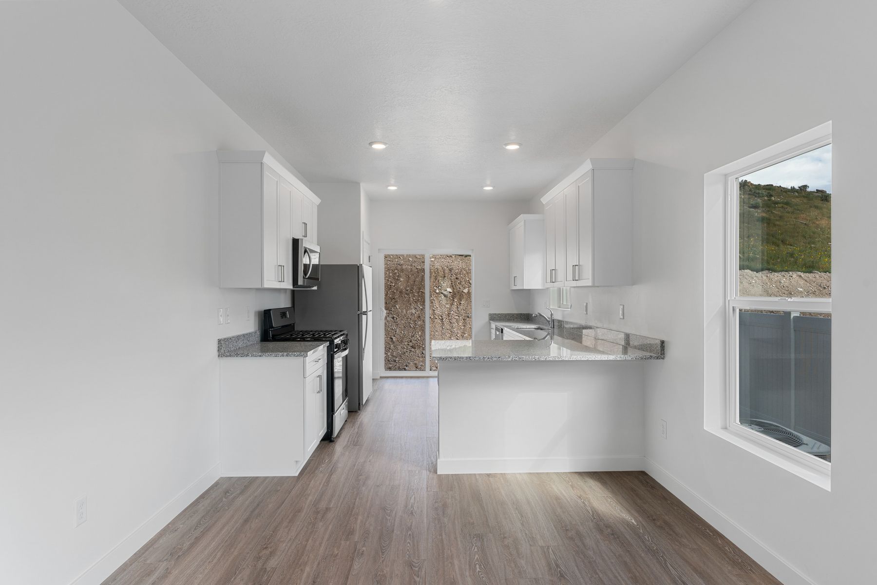 The kitchen has beautiful white wood cabinetry.