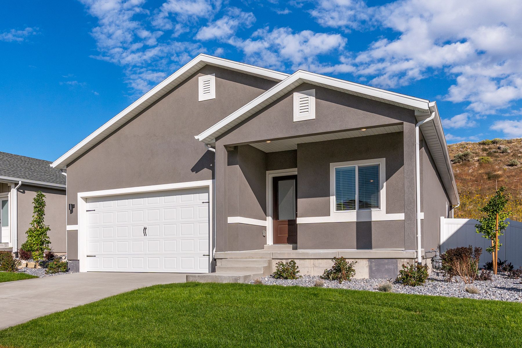 The Glenwood is a beautiful two-story home with a stucco exterior.