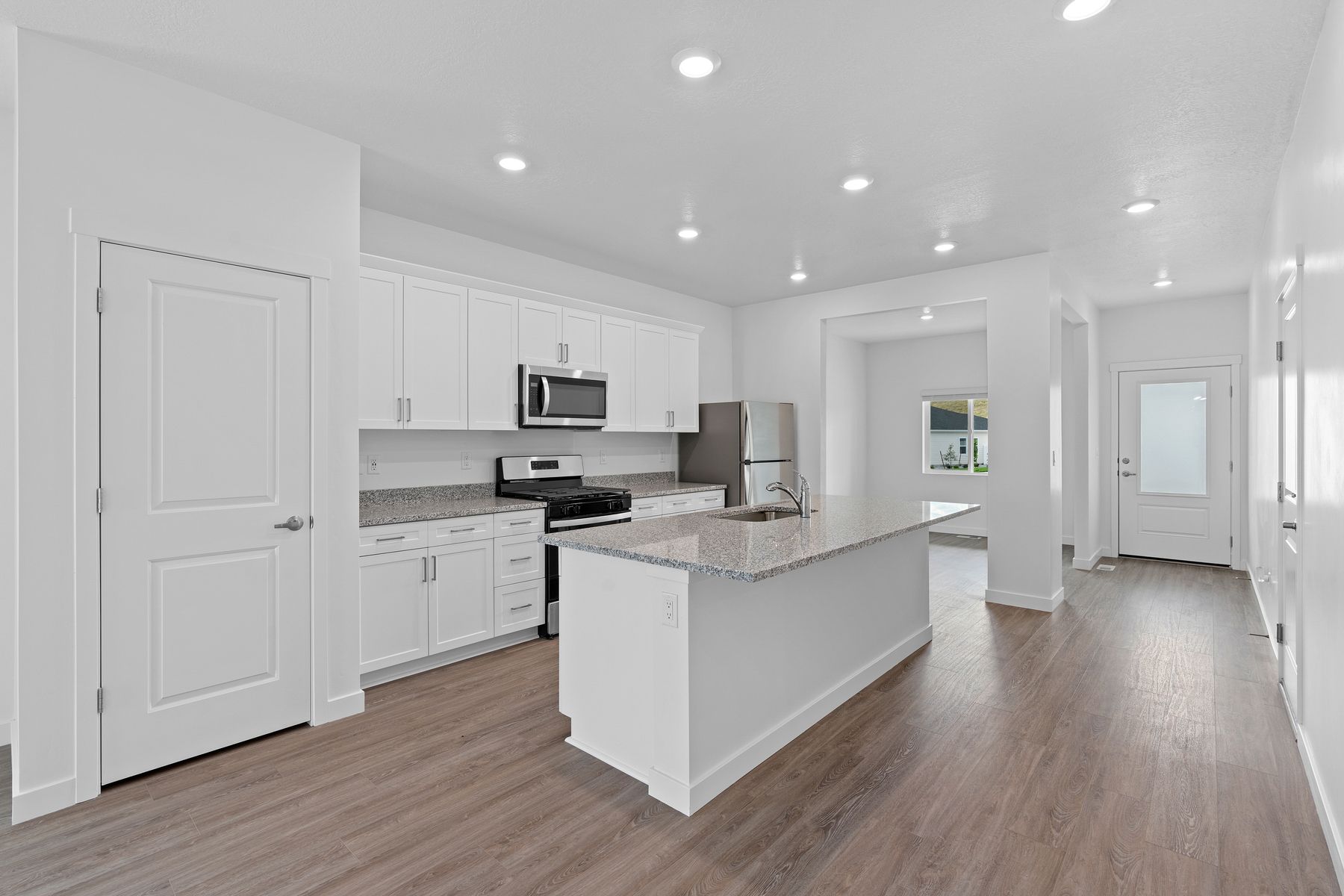 The beautiful kitchen has gorgeous white wood cabinetry.