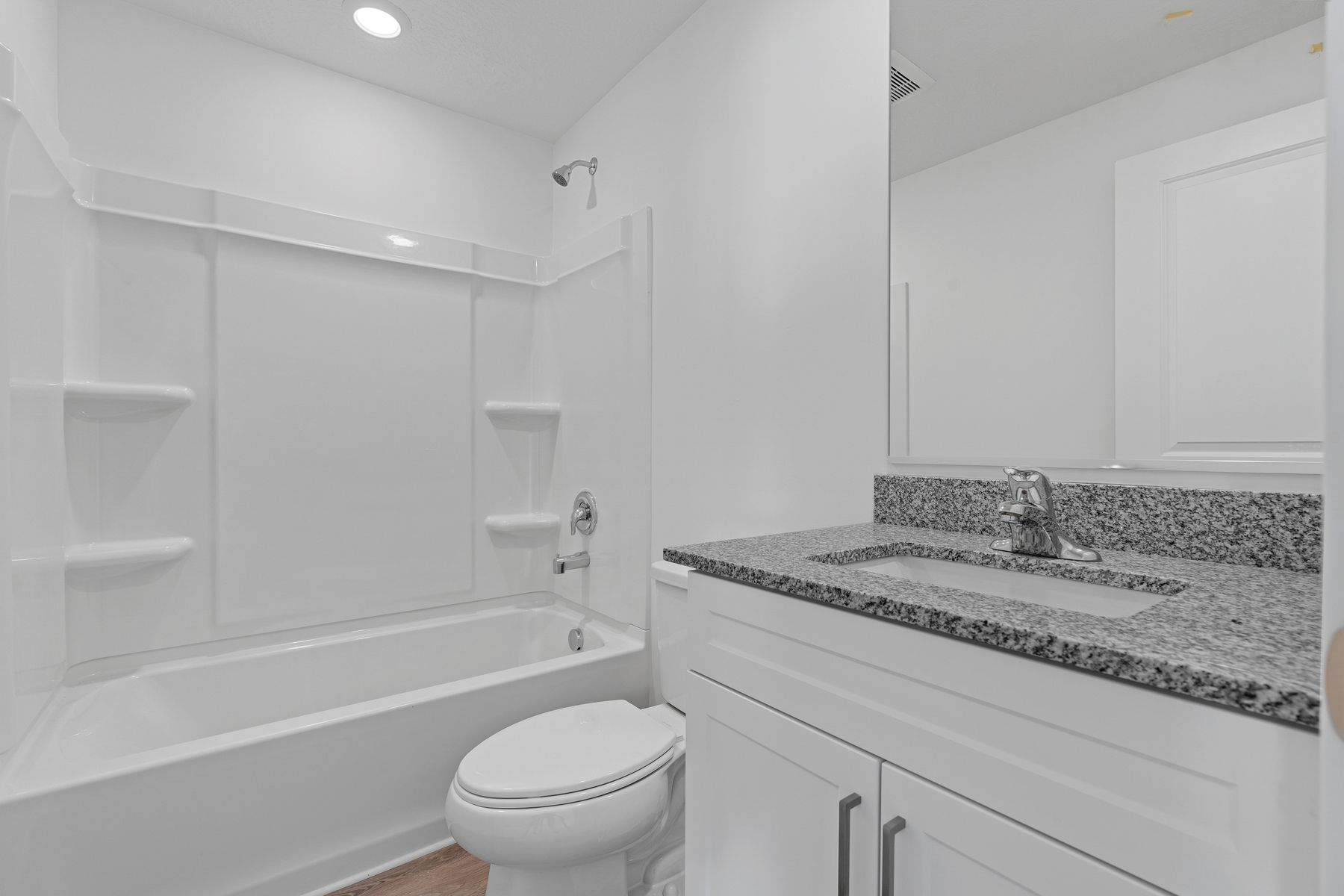 The two secondary bedrooms have large vanity spaces and a shower-tub combo.