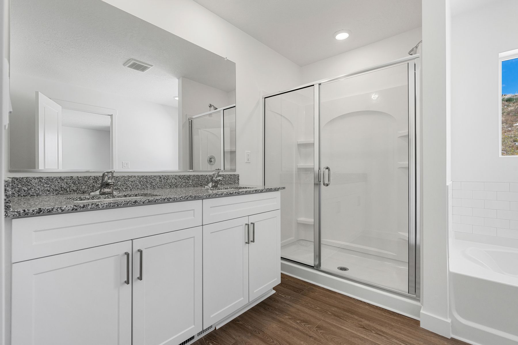 The master bedroom has a walk-in, glass shower.
