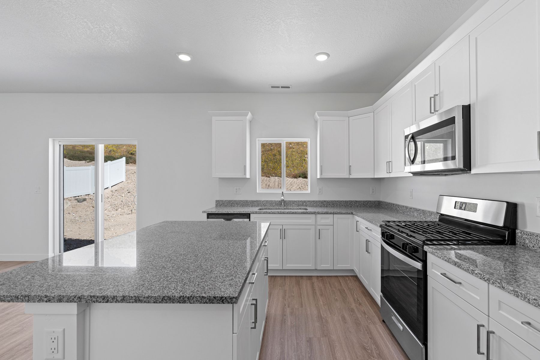 The kitchen has sprawling granite countertops.