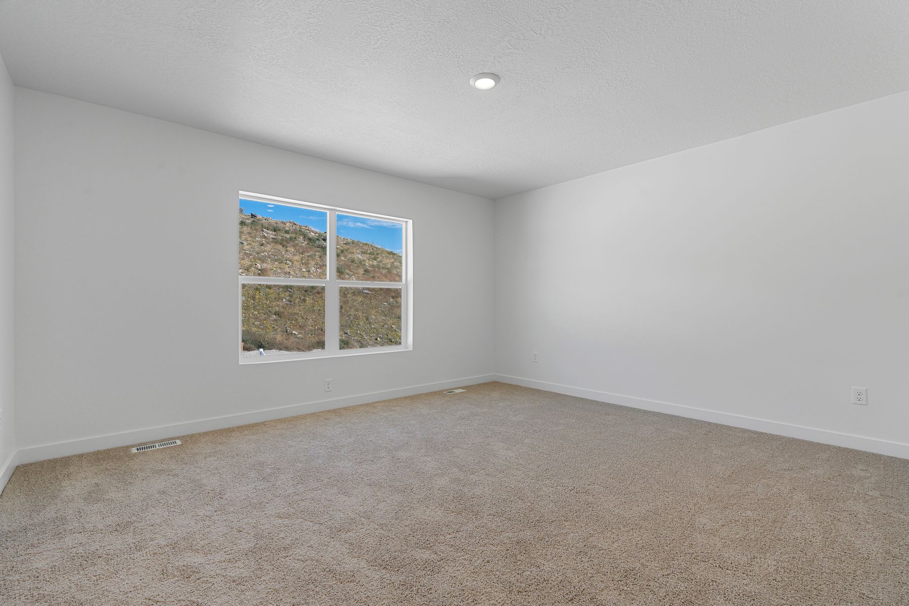 The master bedroom has a large window that lets in great, natural light.
