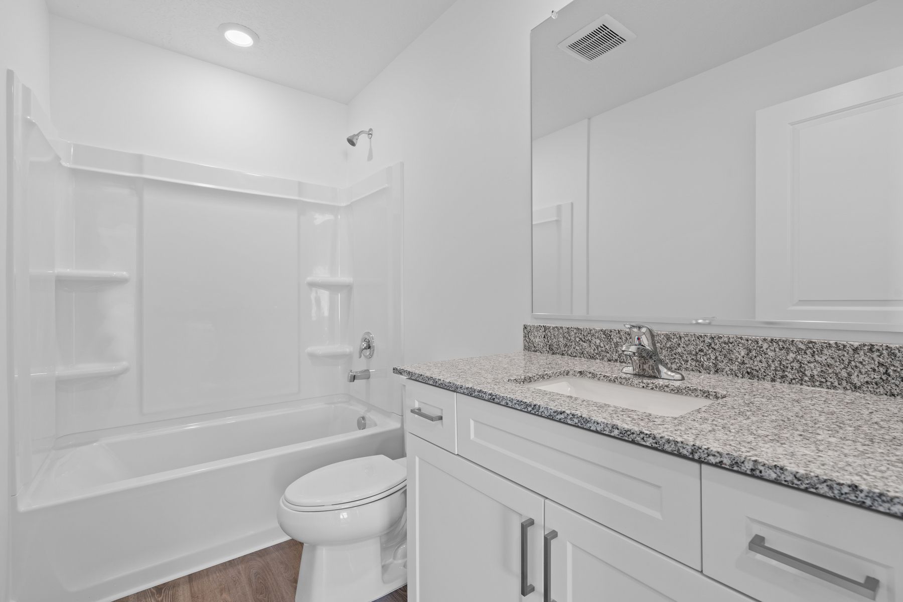 The secondary bathroom comes with a dual shower and bathtub 