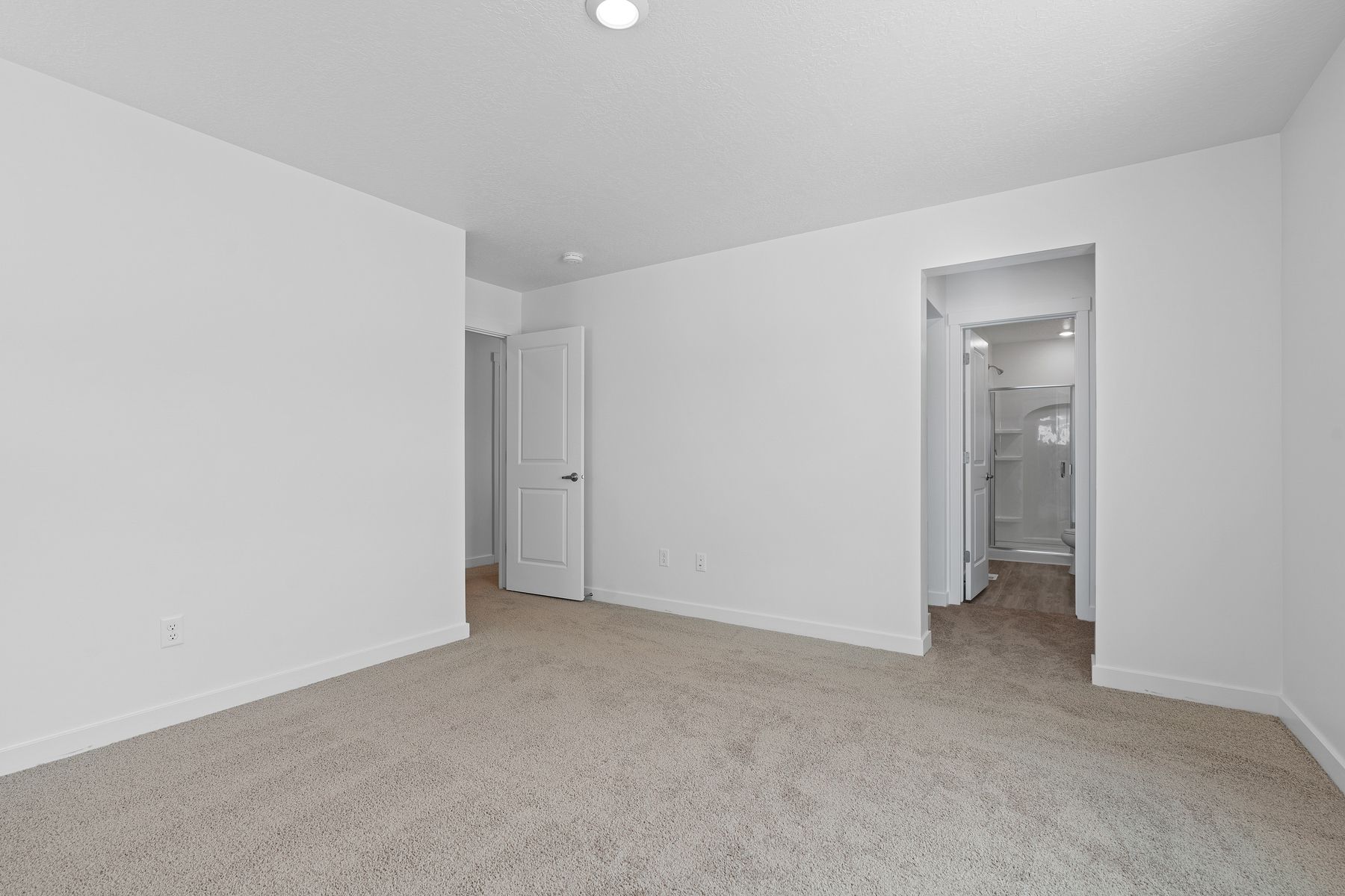 The master suite has a large bedroom, ensuite bathroom and a walk-in closet.
