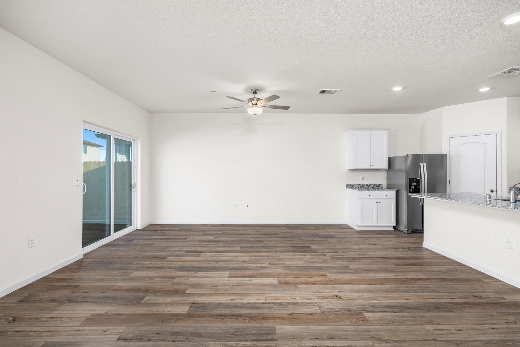 The family room is spacious with a ceiling fan.