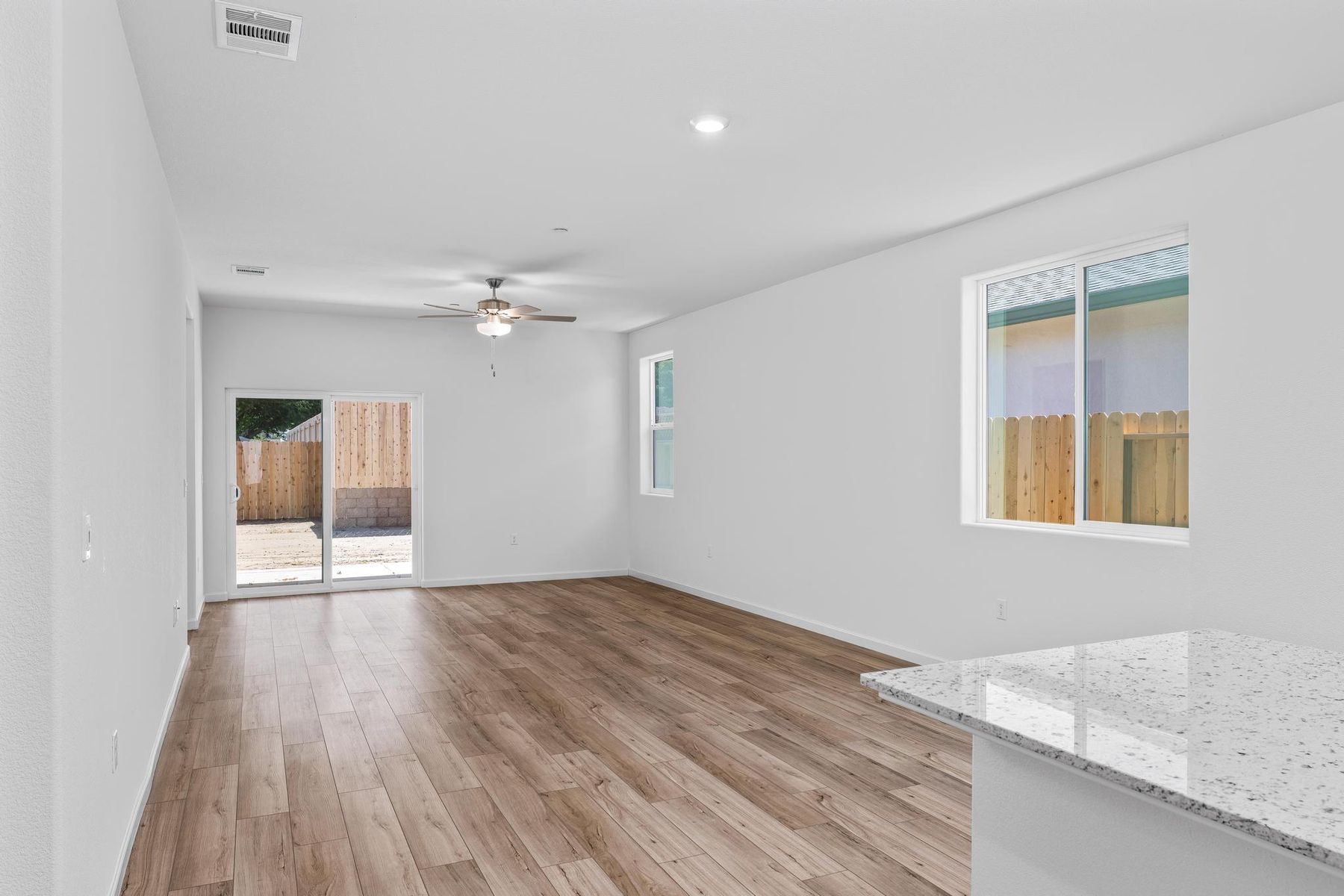 The family room is spacious with a ceiling fan.