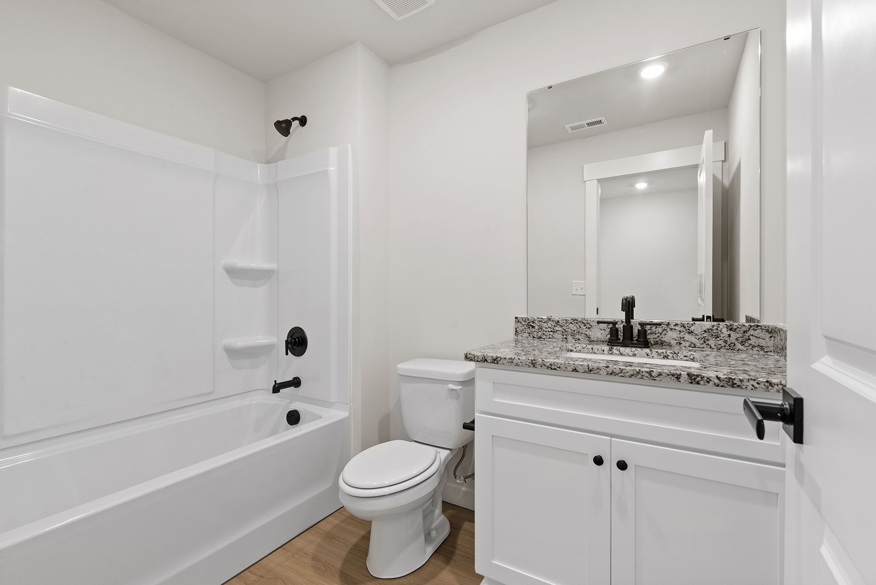 The master bathroom has a glass-enclosed shower