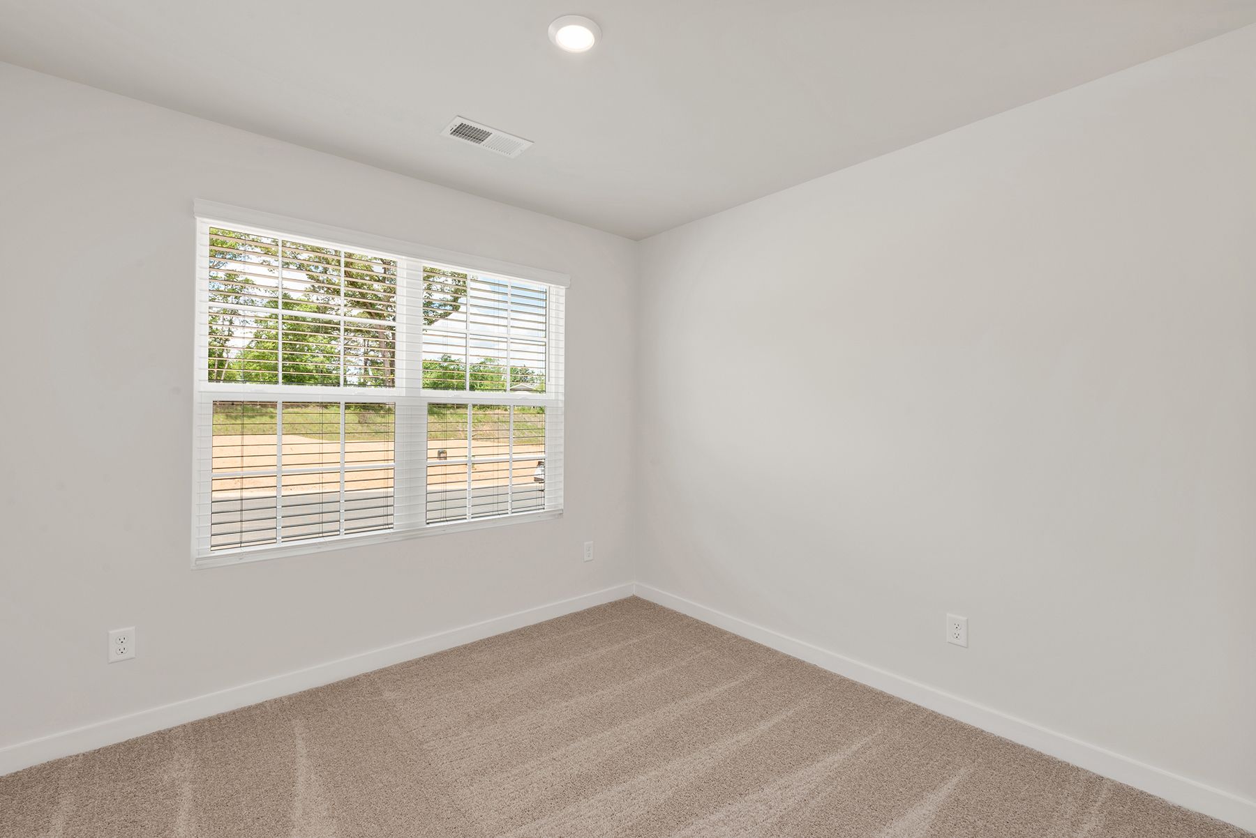 The master bedroom has lots of windows to let in natural light