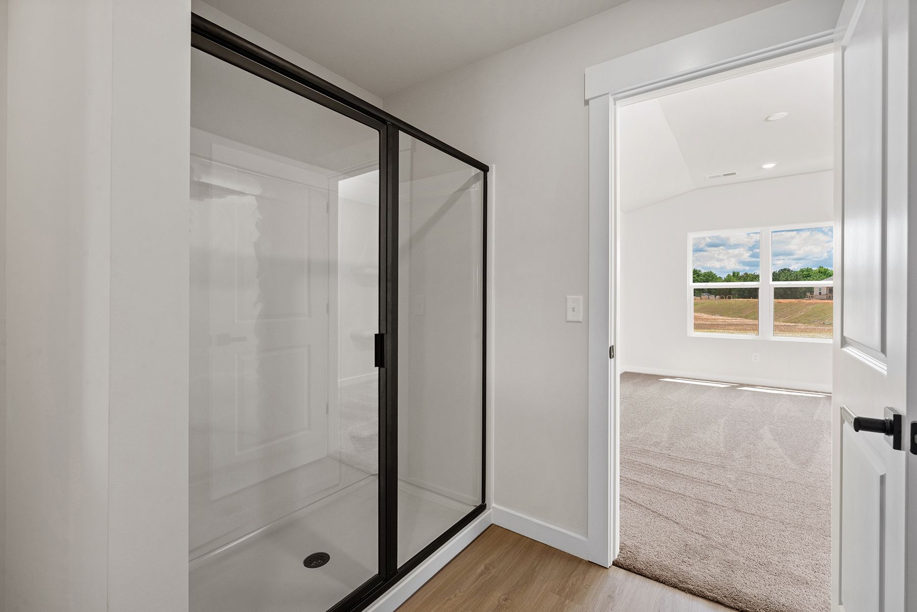 This bathroom has a glass-enclosed shower