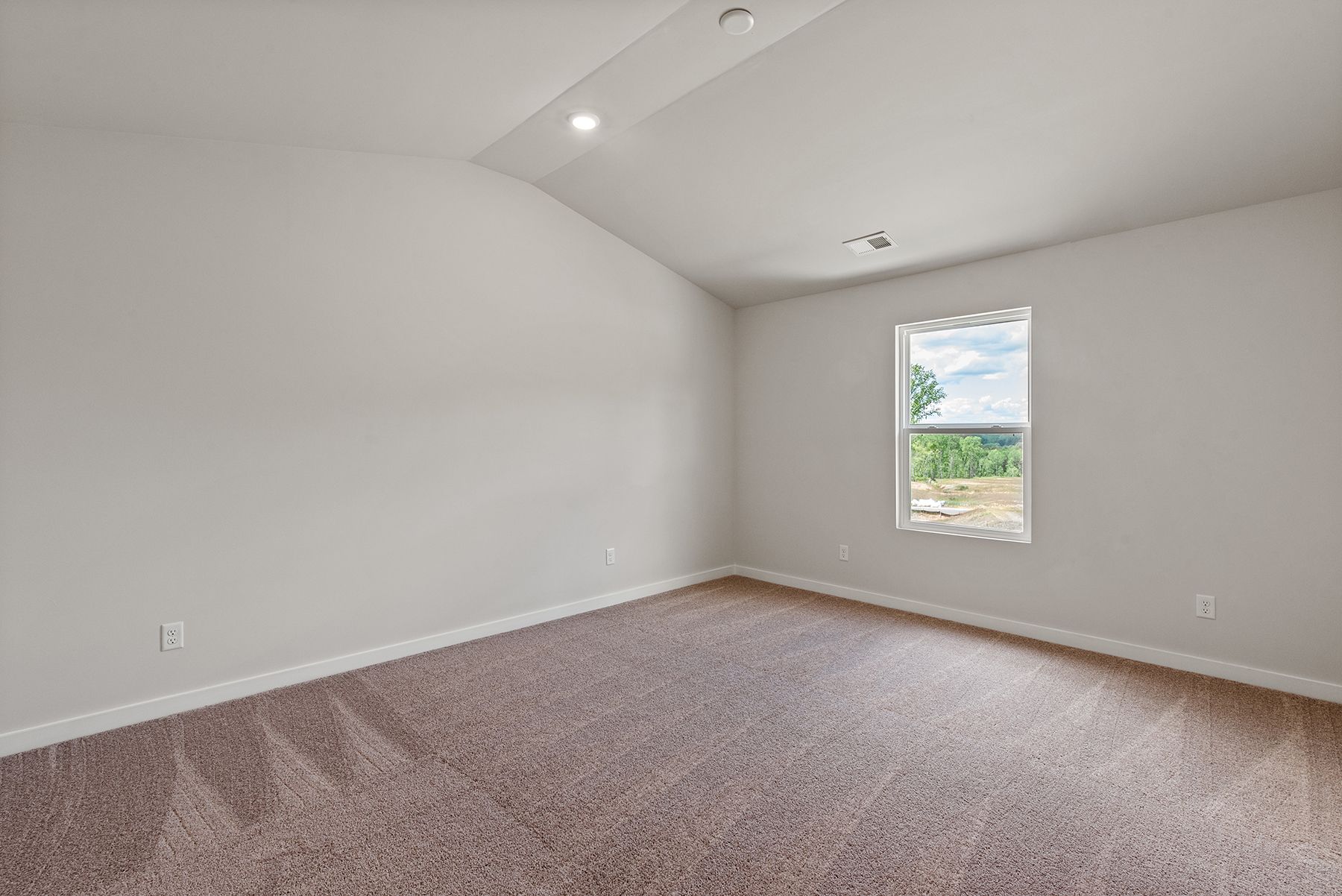 The master bedroom has large windows and carpet.