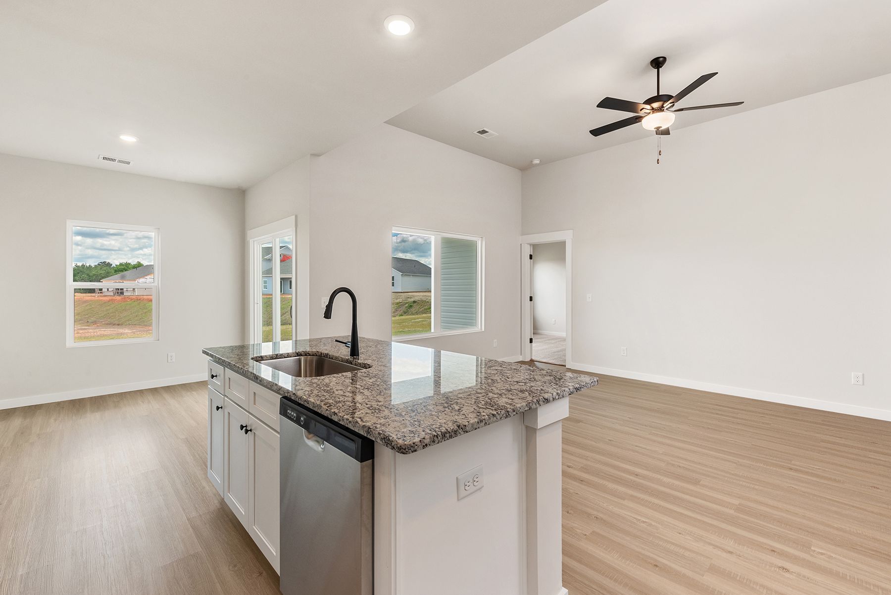 The kitchen has designer wood cabinetry