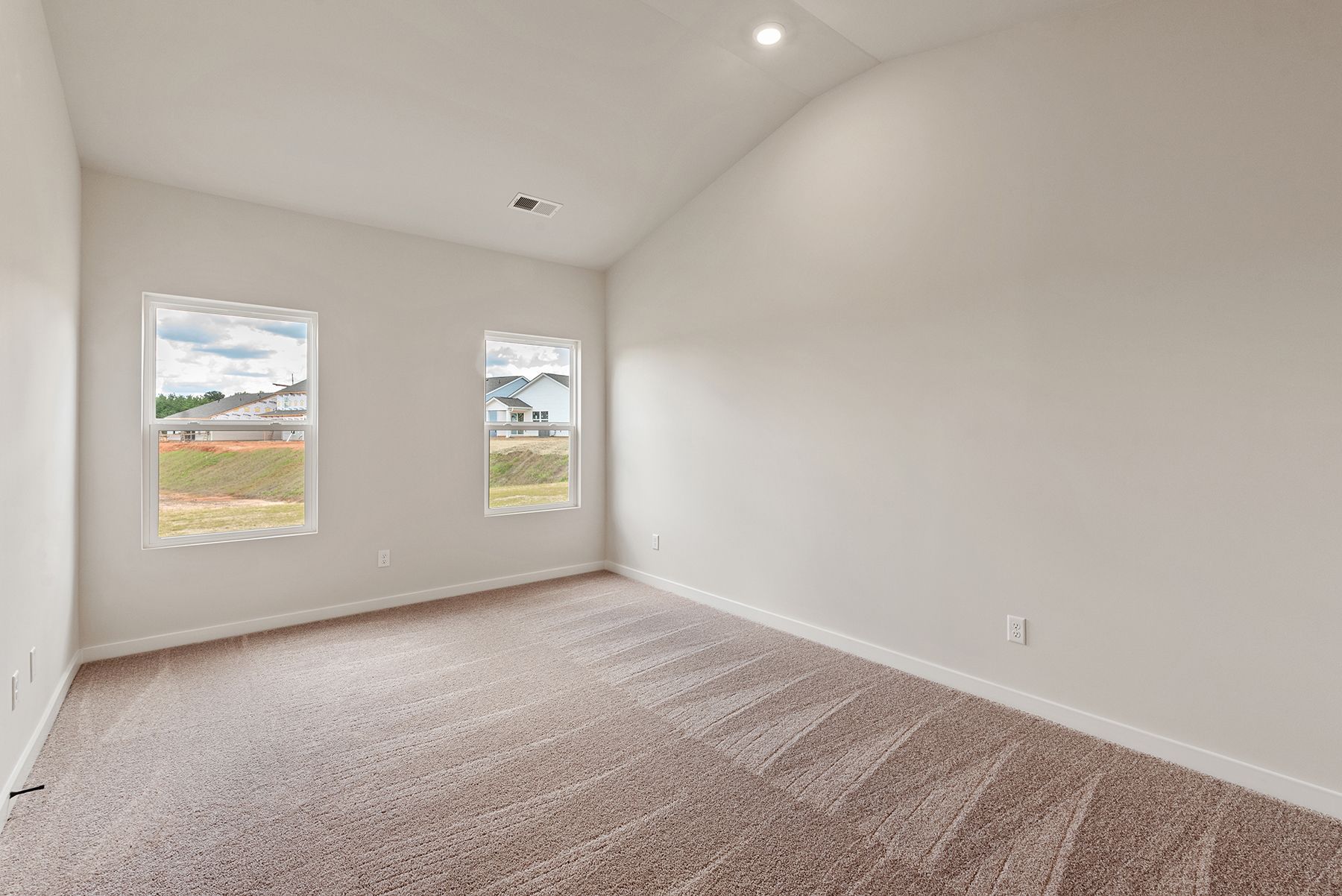 The master bedroom has lots of windows to let in natural light