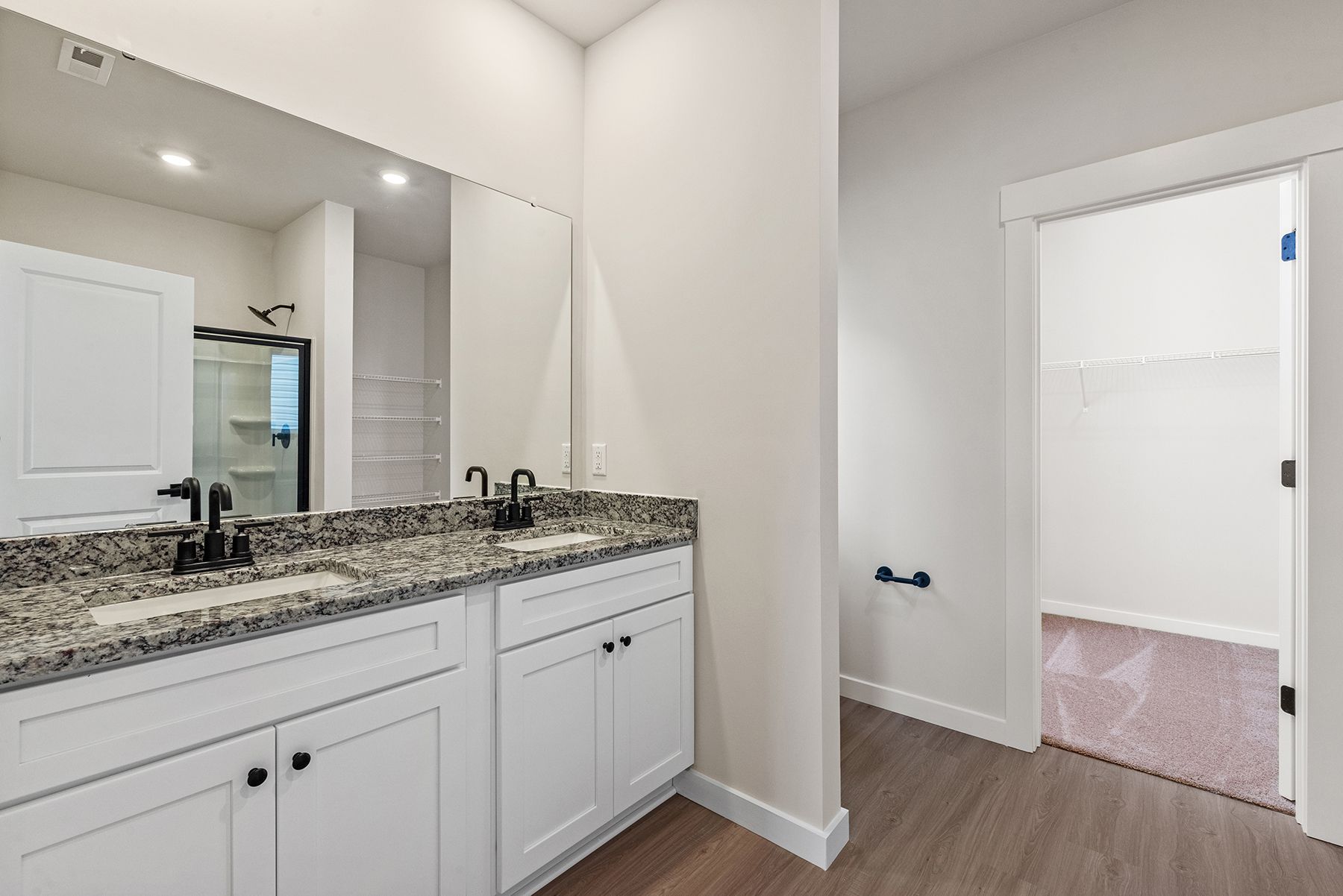 The master bathroom has a glass-enclosed shower