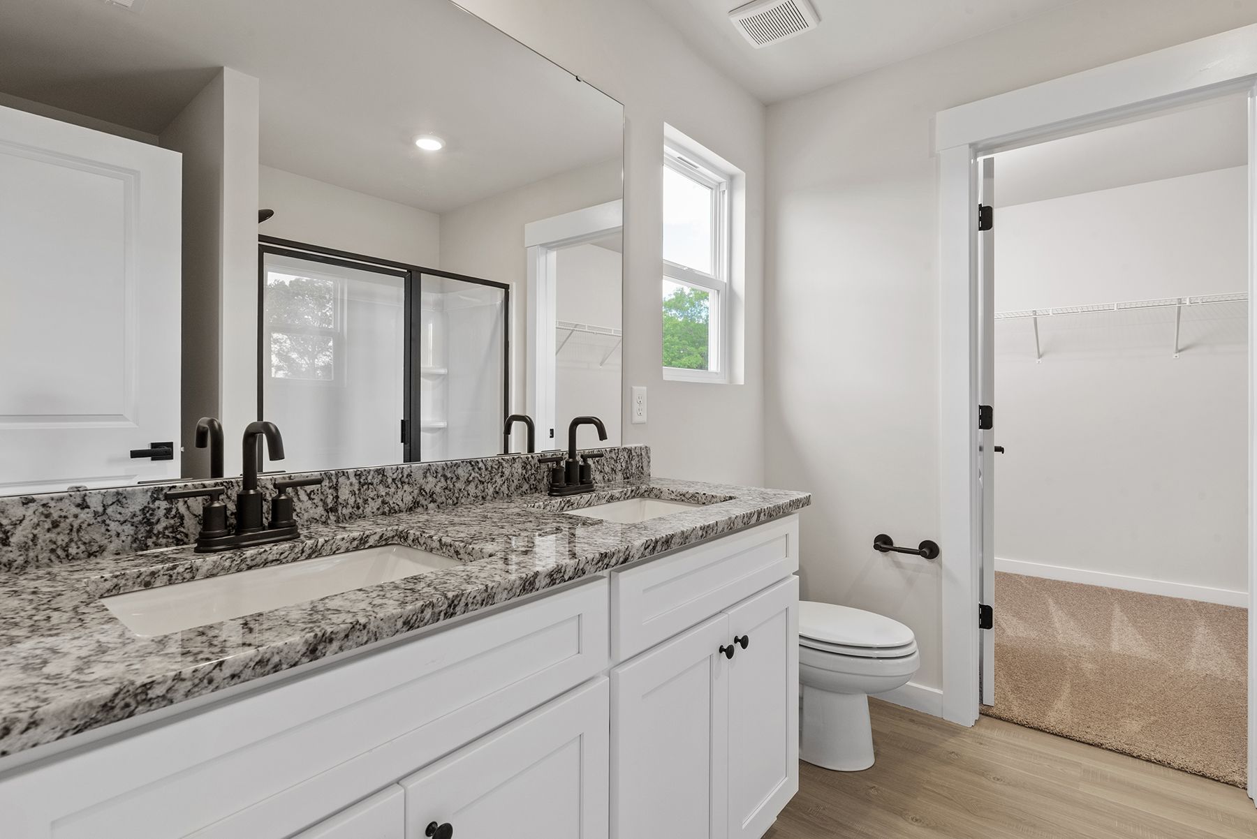 This bathroom has a glass-enclosed shower