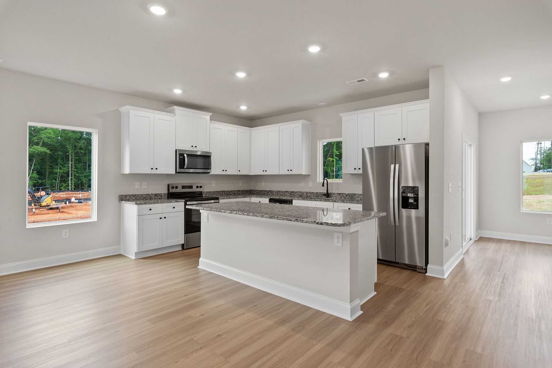 The kitchen has a spacious granite countertops
