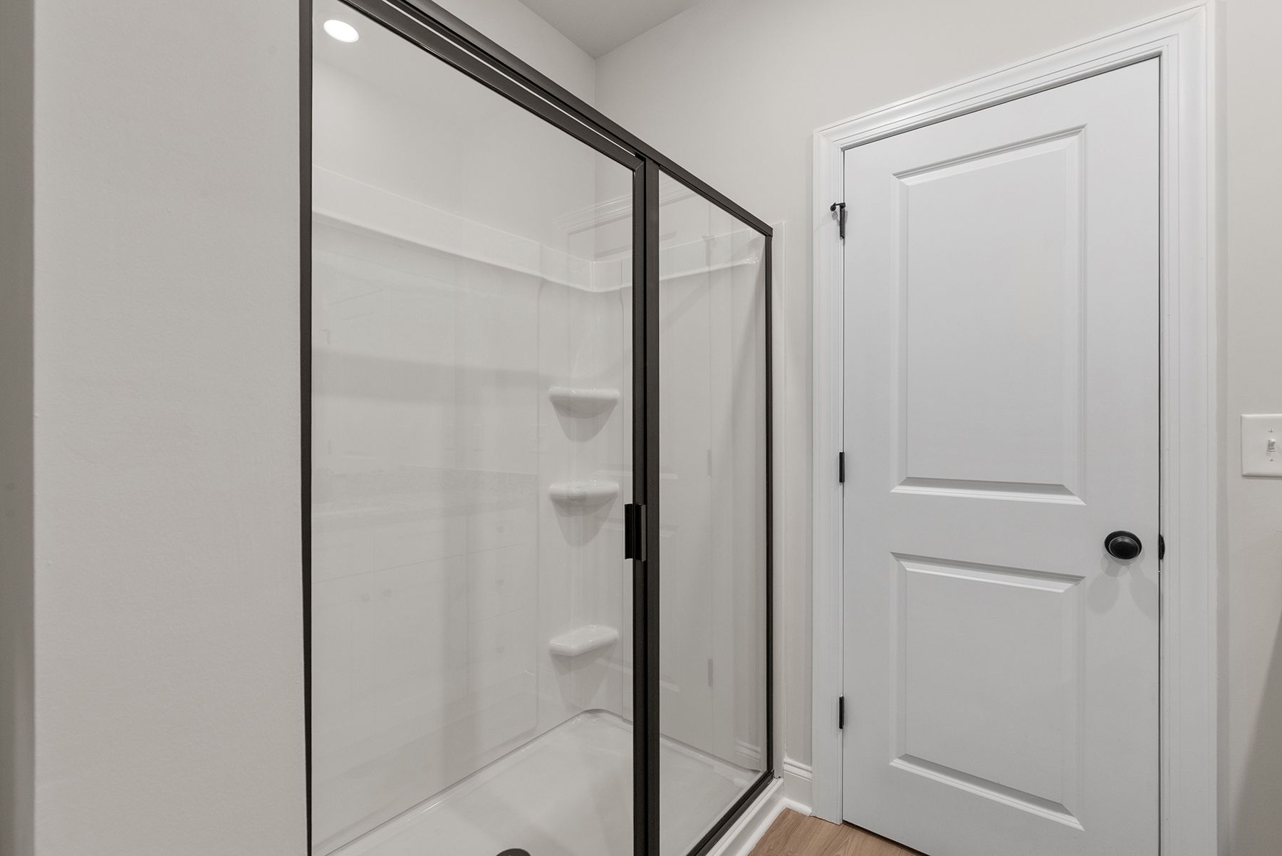 This bathroom has a glass-enclosed shower