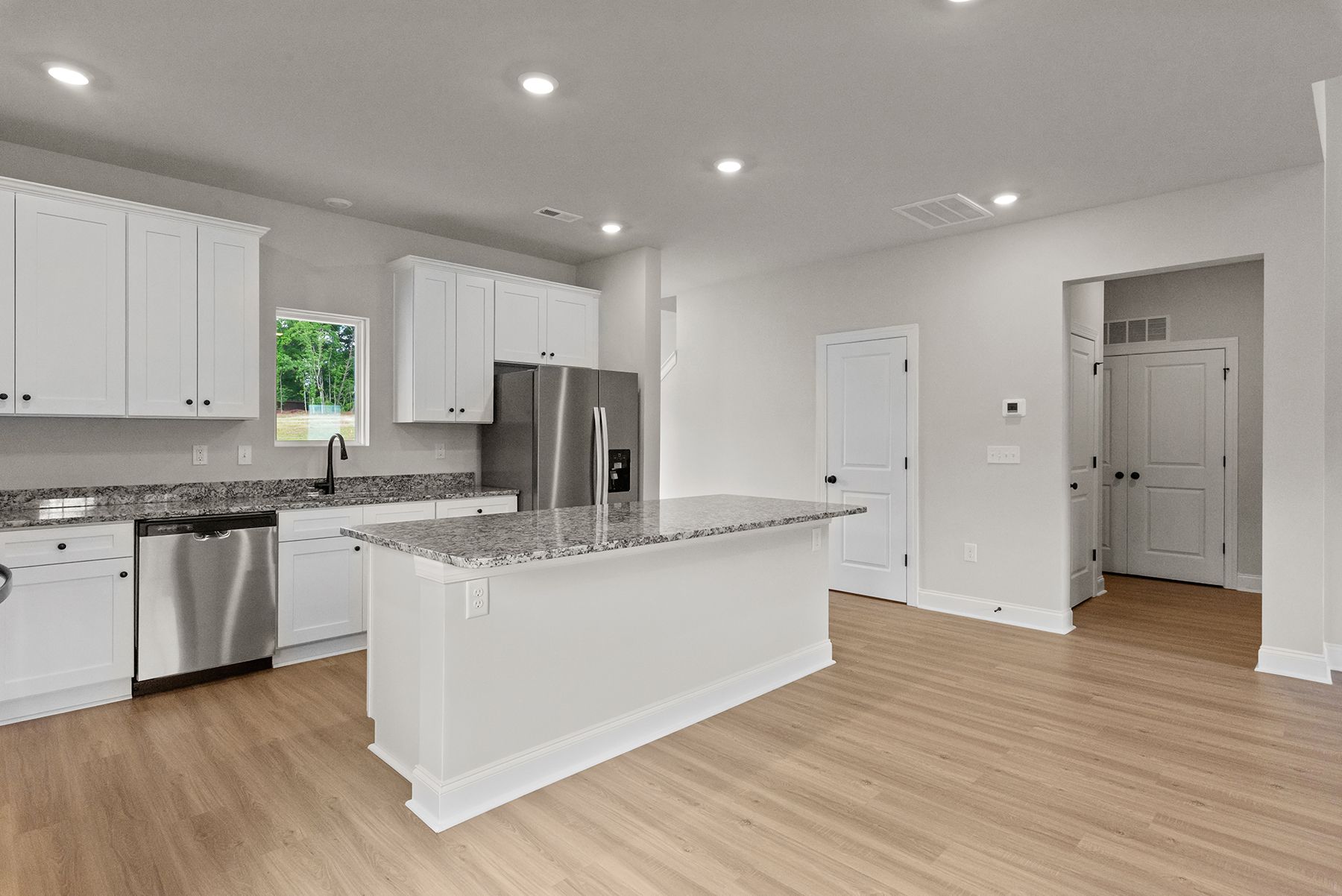 The kitchen has a spacious granite countertops