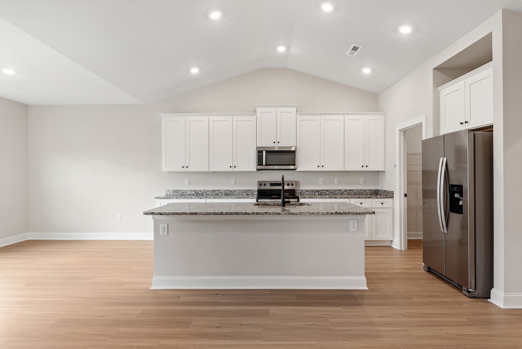 The kitchen has wood cabinetry