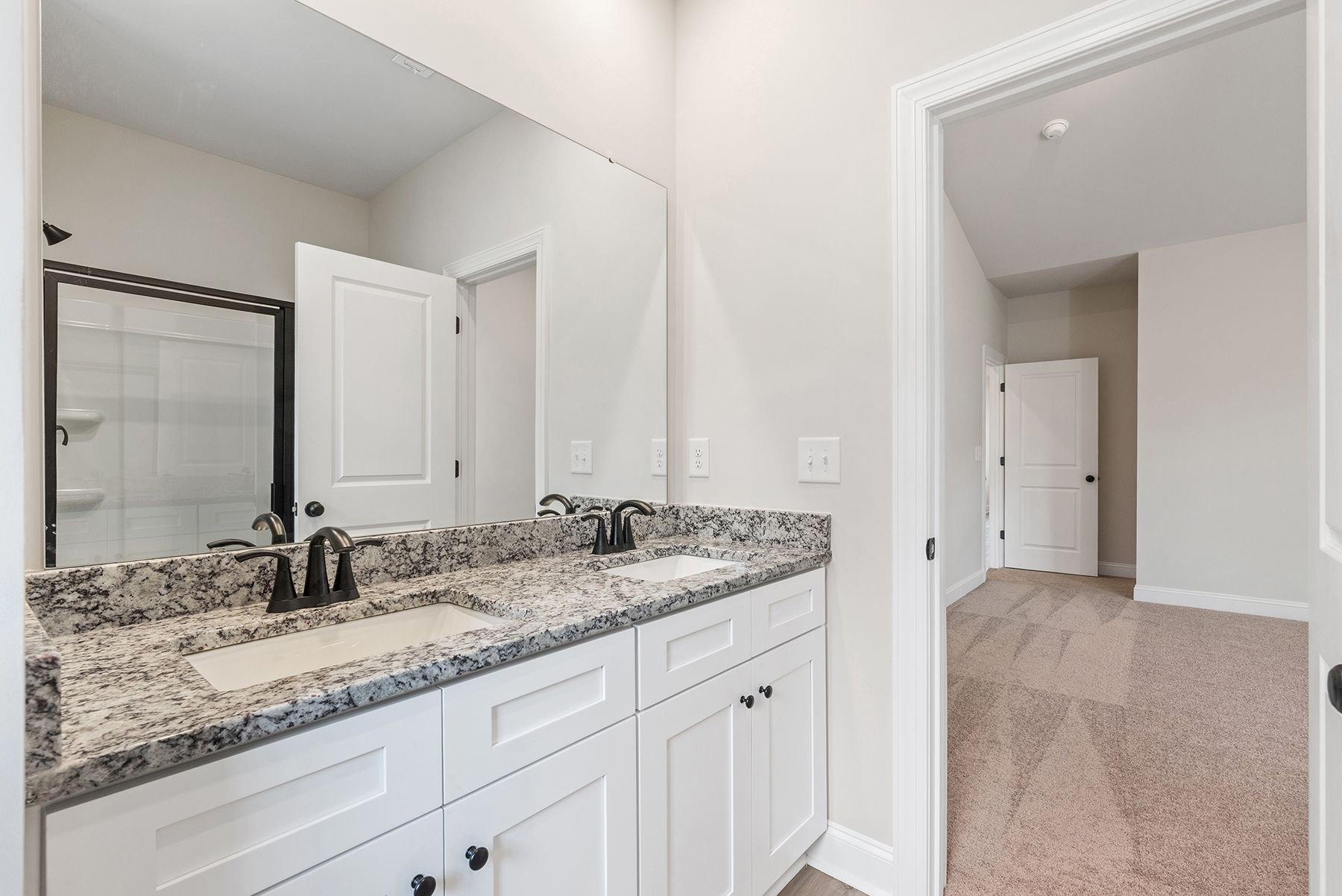 This bathroom has granite countertops