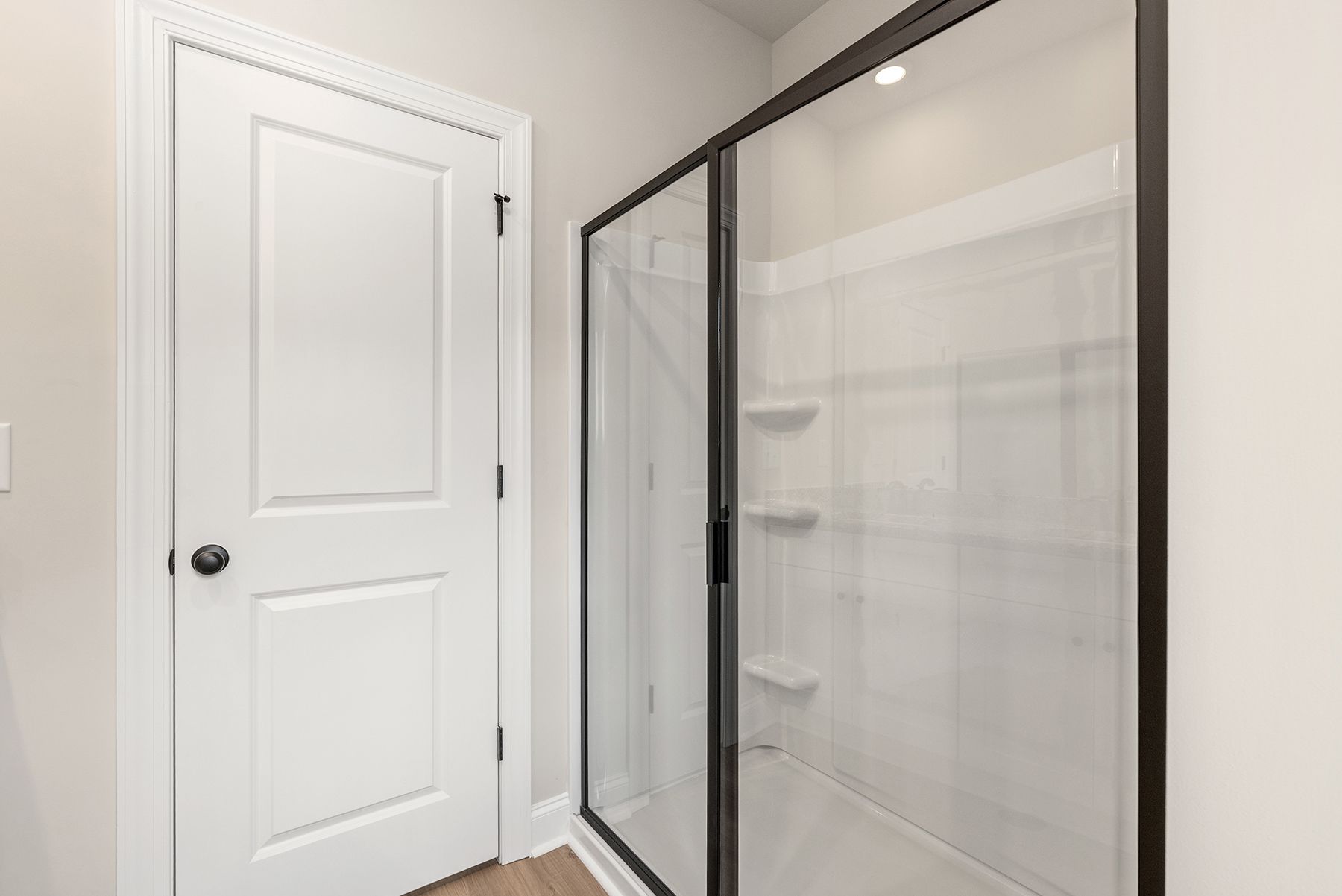 This bathroom has a glass-enclosed shower