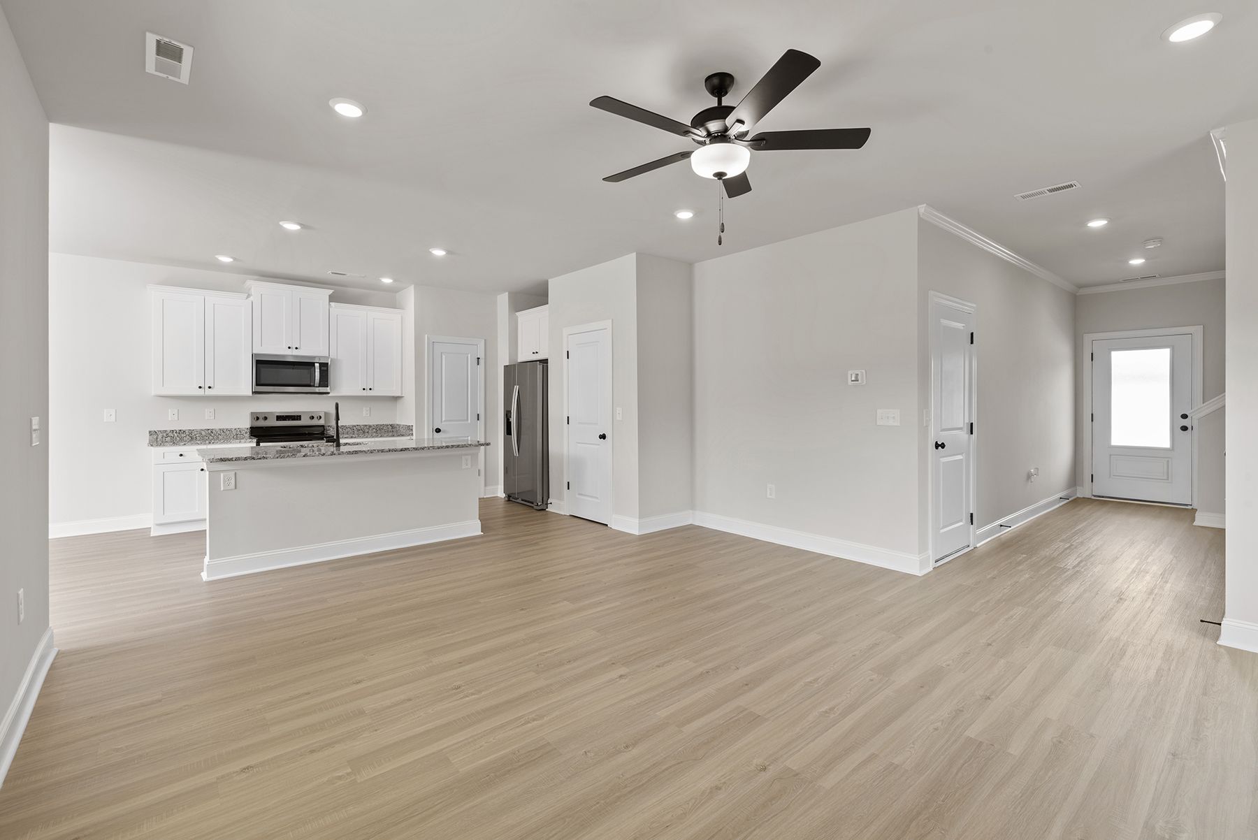 The kitchen has designer wood cabinetry