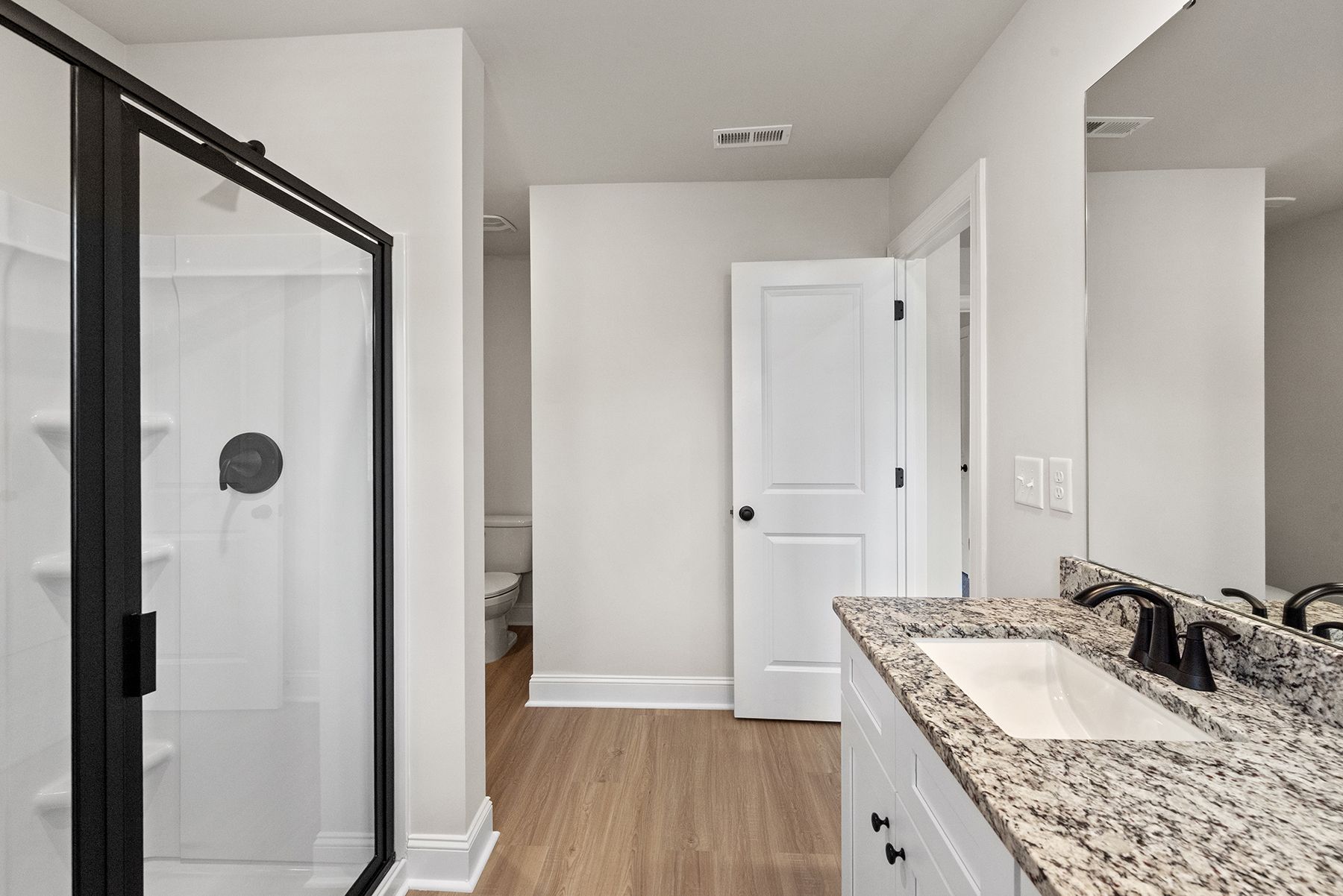 The master bathroom has a glass-enclosed shower
