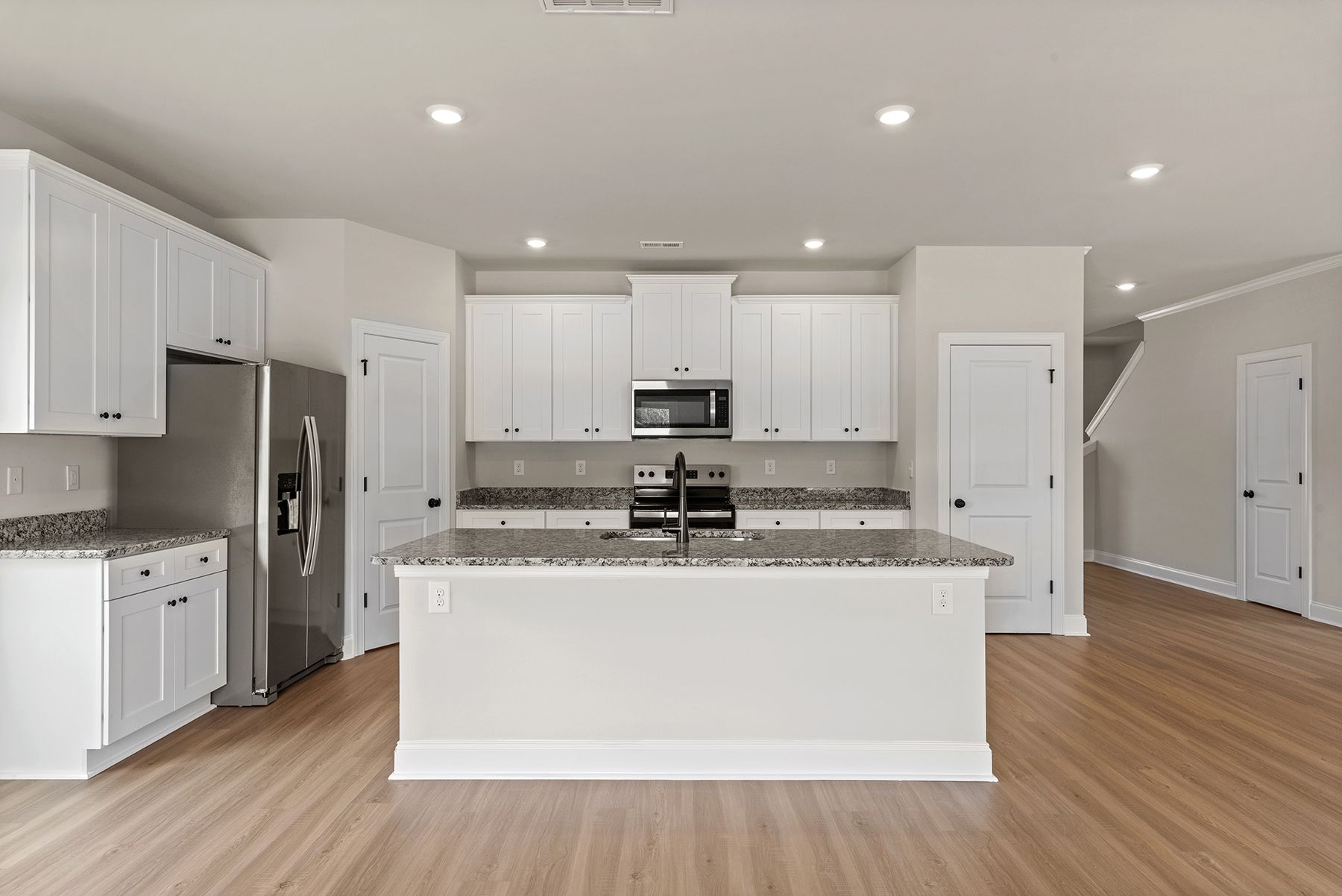 The kitchen has designer wood cabinetry