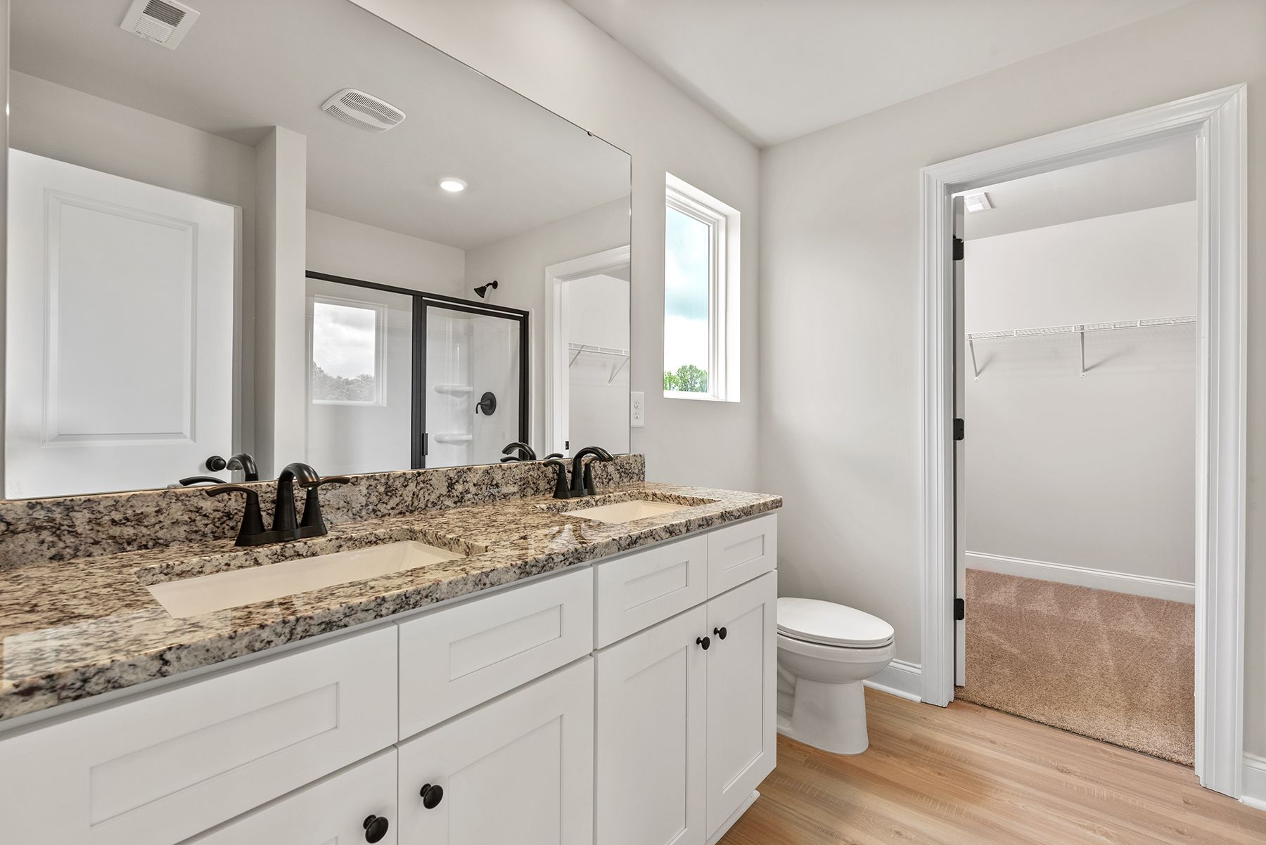 The master bathroom has a glass-enclosed shower