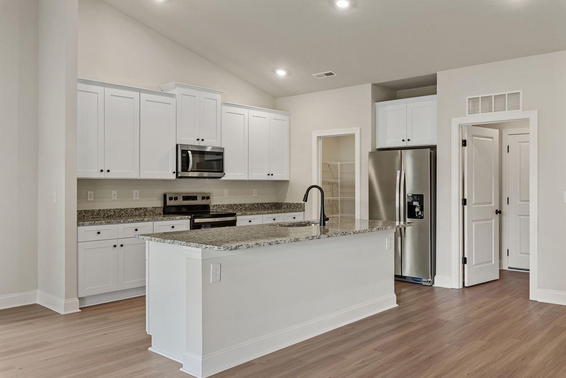 The kitchen has wood cabinetry