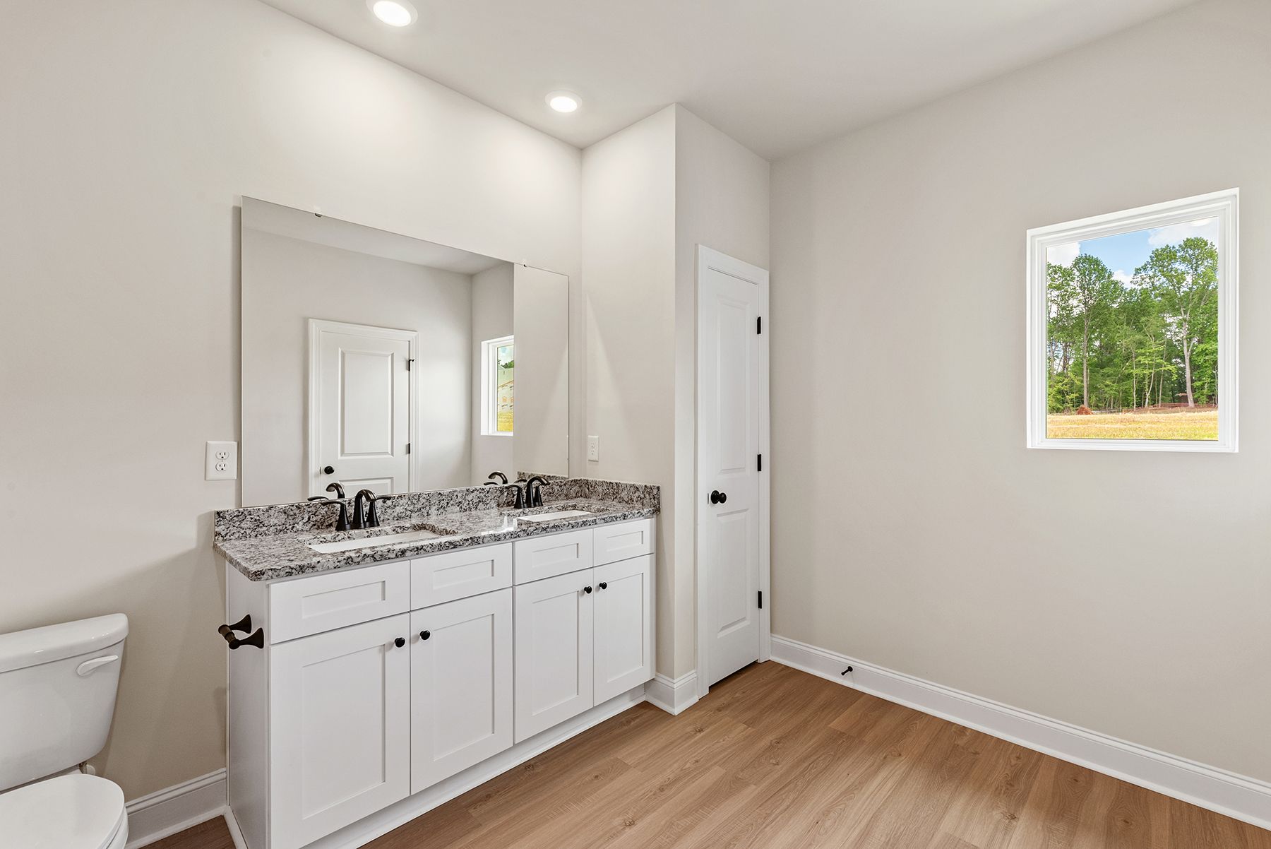 This bathroom has granite countertops